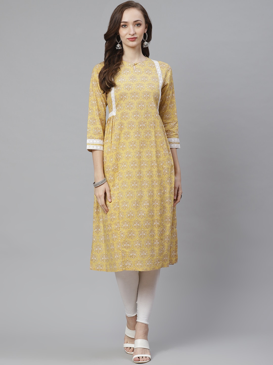 

Bhama Couture Keyhole Neck Ethnic Motifs Printed Thread Work A-Line Pure Cotton Kurta, Yellow