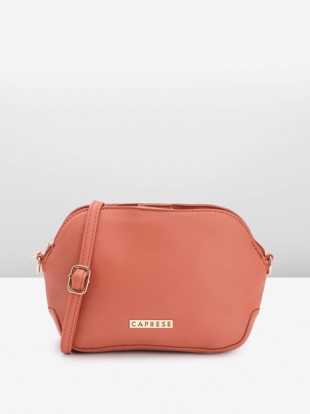 

Caprese Women Solid Sling Bag, Peach