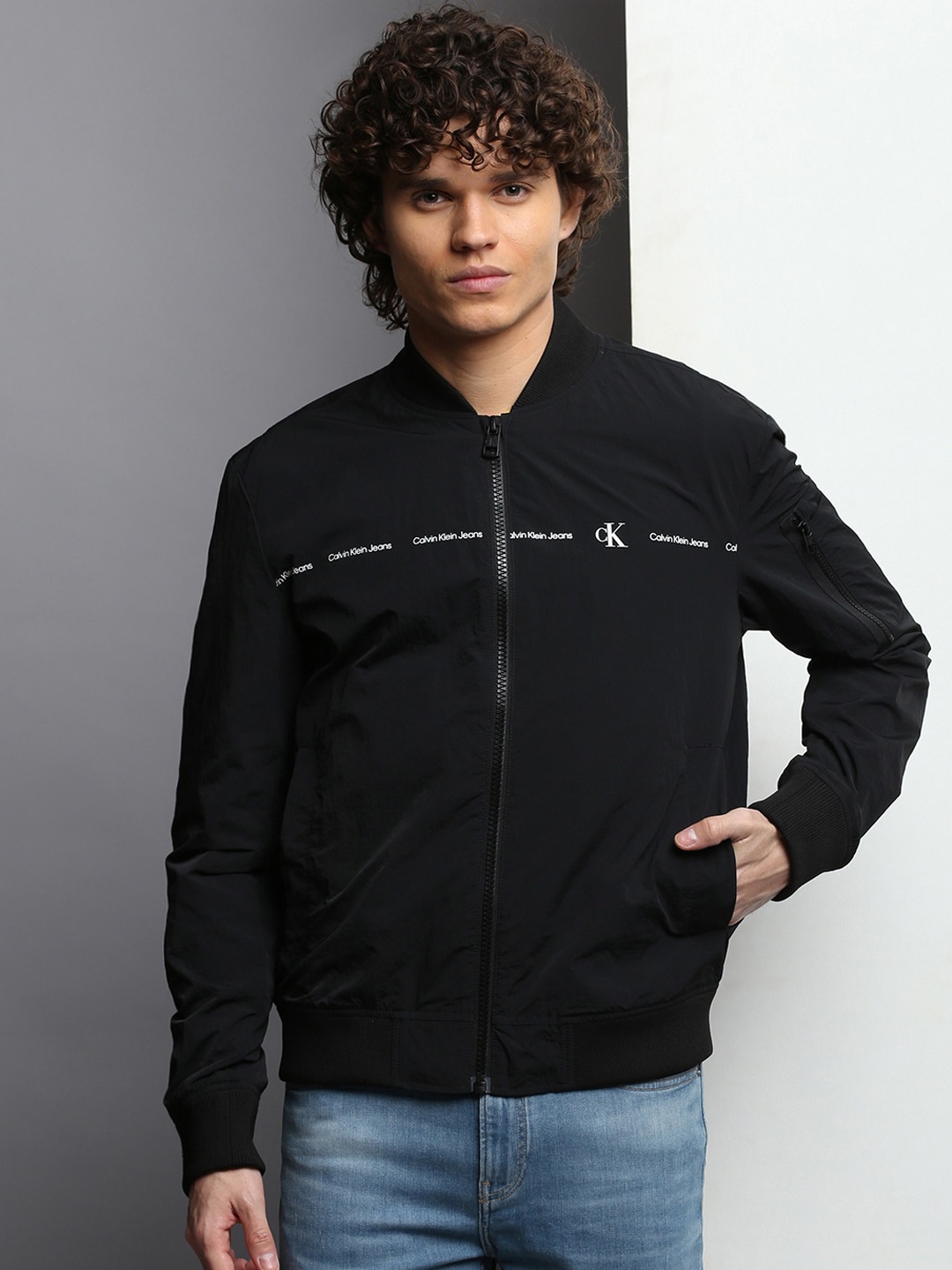 

Calvin Klein Jeans Brand Logo Printed Zip-Detail Stand Collar Bomber Jacket, Black