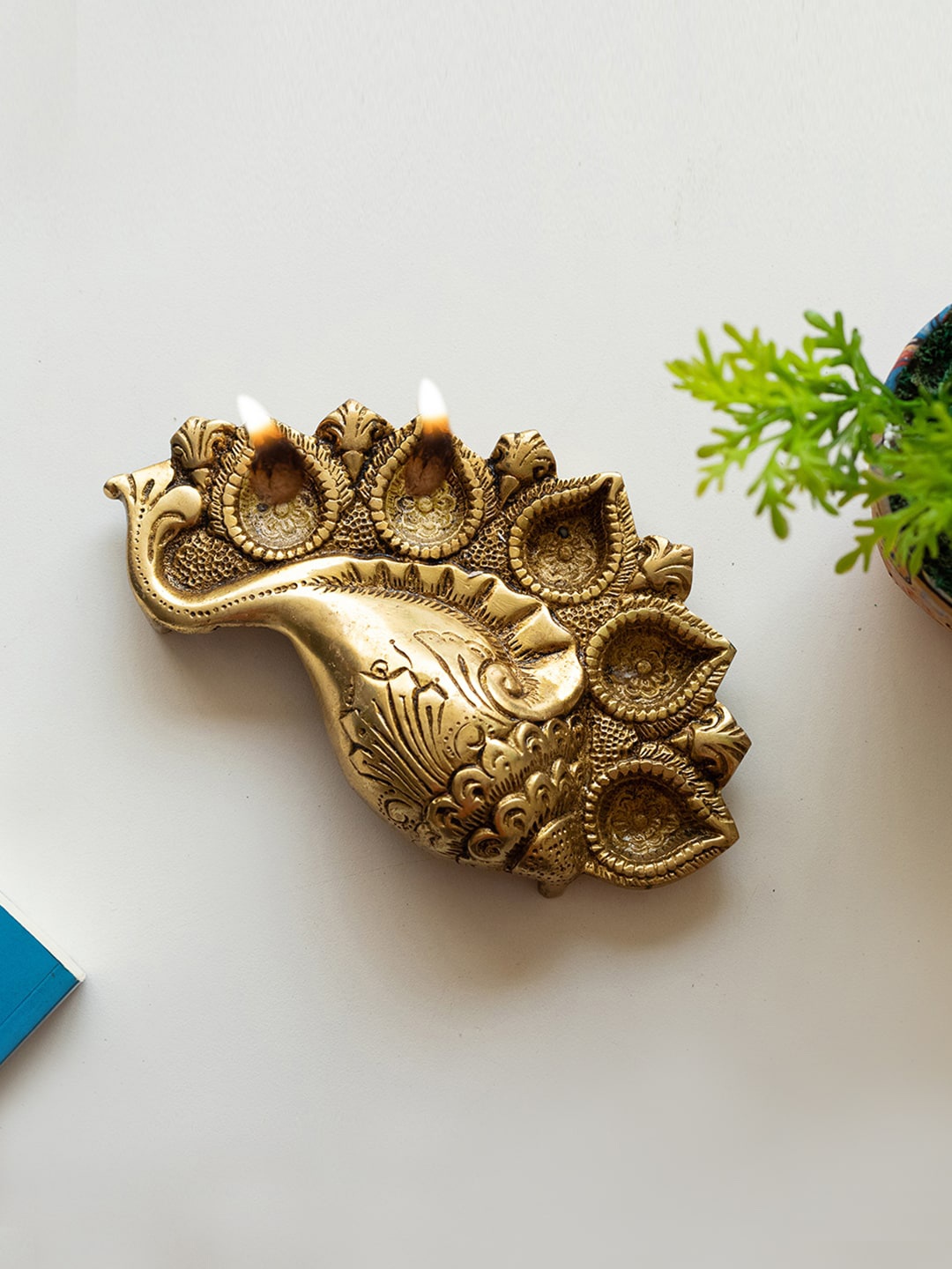 

ExclusiveLane Gold-Toned Textured Shankh Shaped Brass Diya