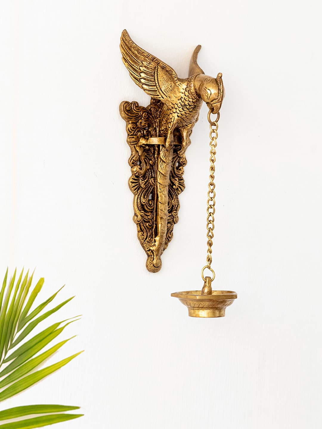 

ExclusiveLane Gold-Toned Textured Parrot Shaped Brass Wall Hanging Diya