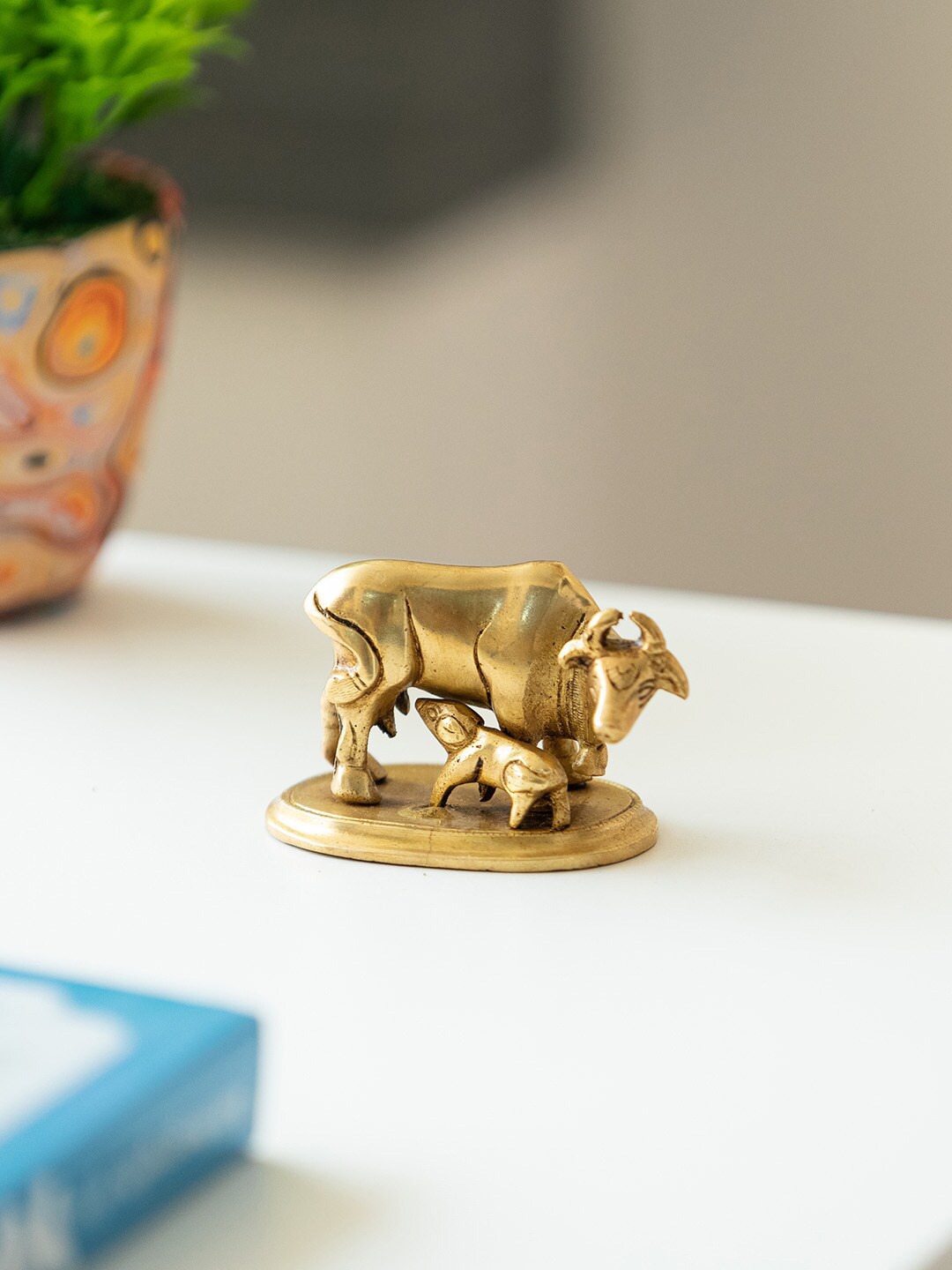 

ExclusiveLane Gold-Toned Kamdhenu Cow With Calf Brass Showpiece Idol