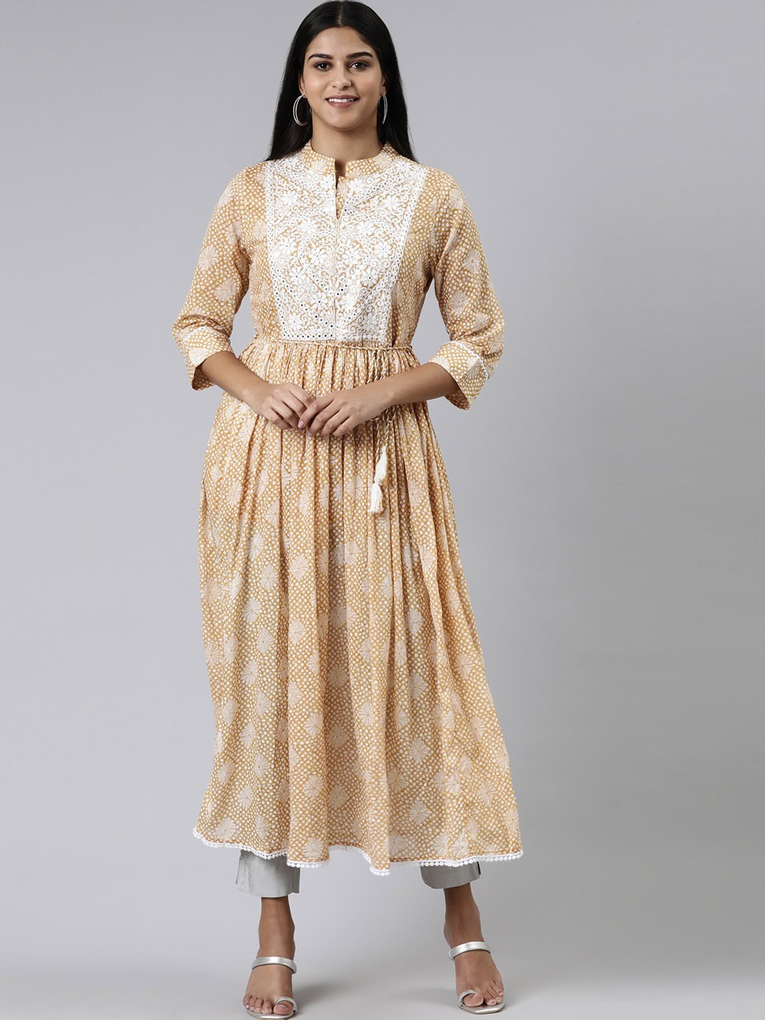 

Neerus Ethnic Motifs Printed Mirror Work Pleated A-Line Cotton Kurta, Beige