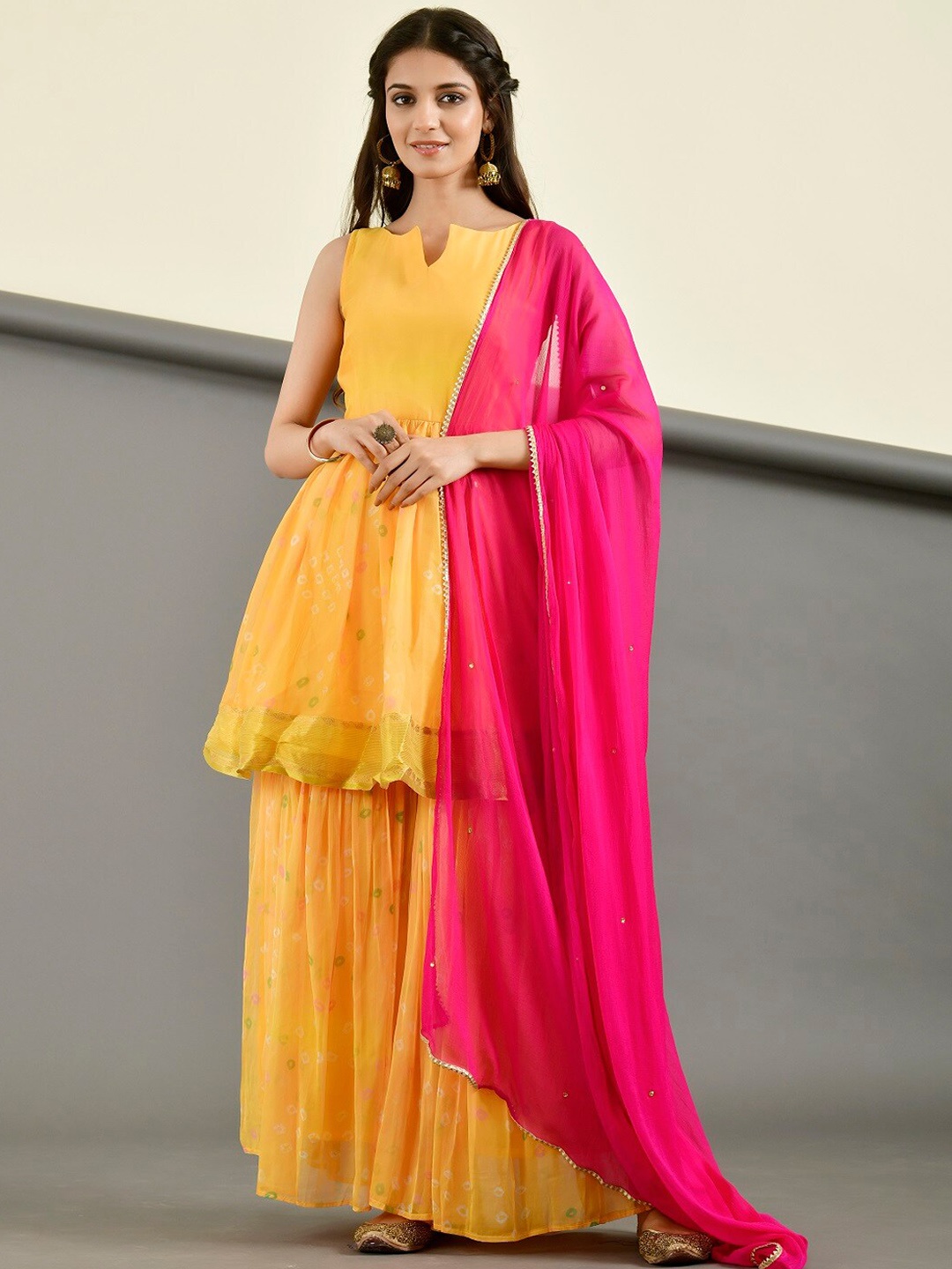 

Rangpur Bandhani Printed Notch Neck Sleveeless Pure Cotton Kurta with Sharara & Dupatta, Yellow
