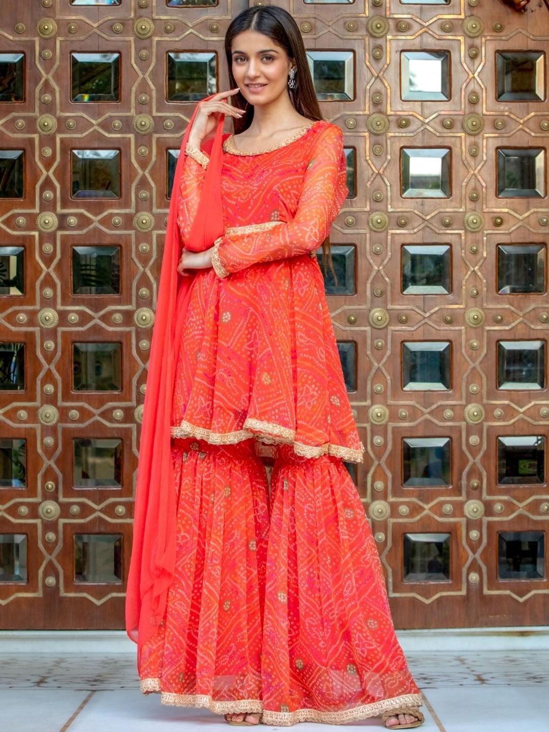 

HOUSE OF JAMOTI Women Orange Bandhani Printed Kurti with Sharara & With Dupatta