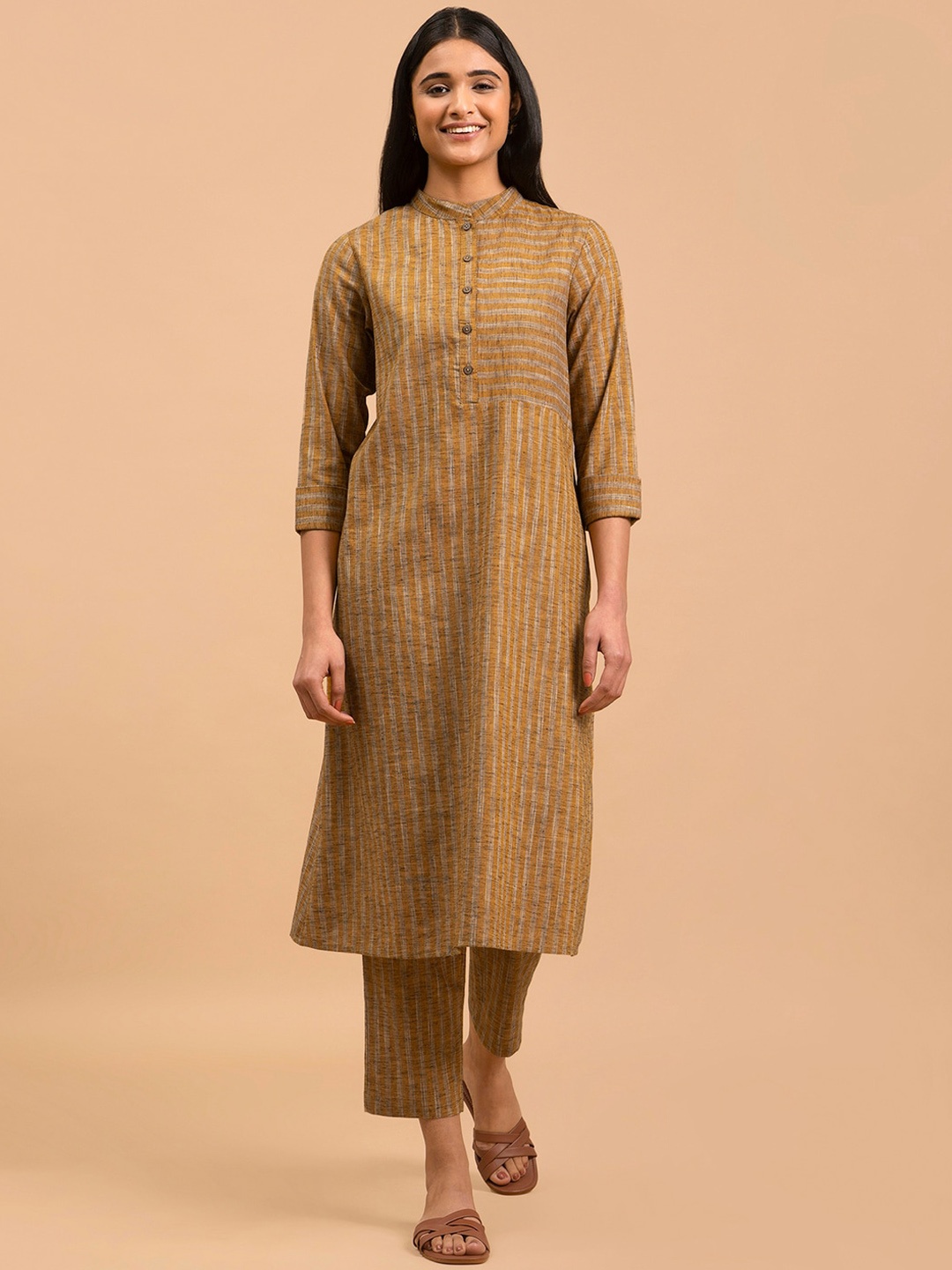 

Pink Fort Striped Band Collar A-Line Kurta with Trousers, Mustard