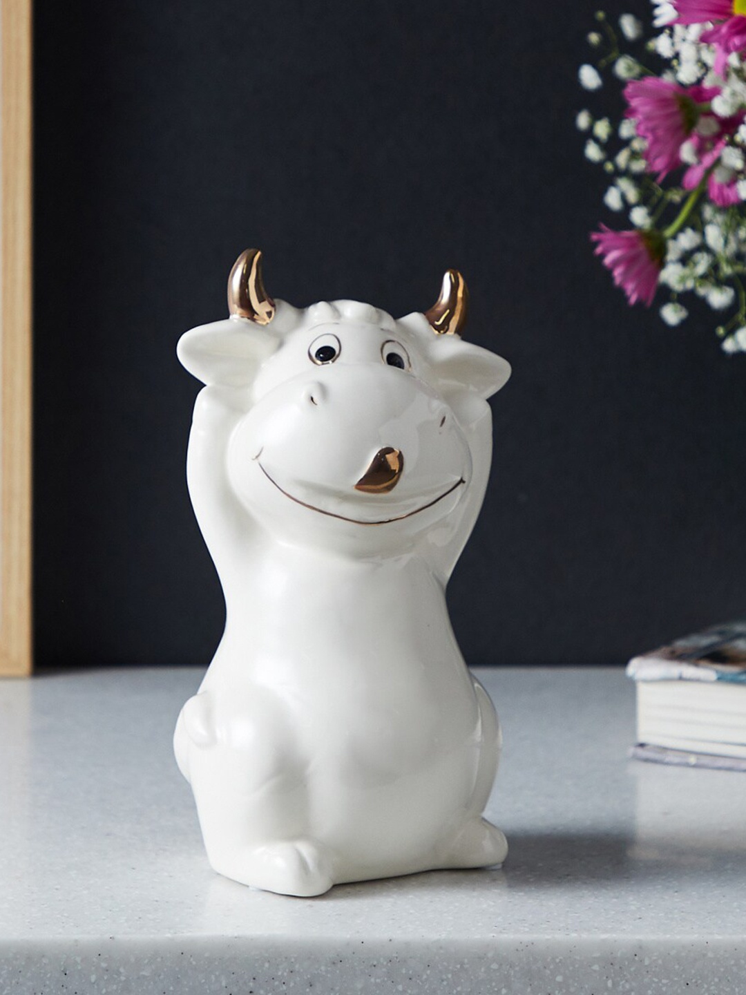 

Home Centre Brighton White Textured Cow Hands Up Figurine Showpiece