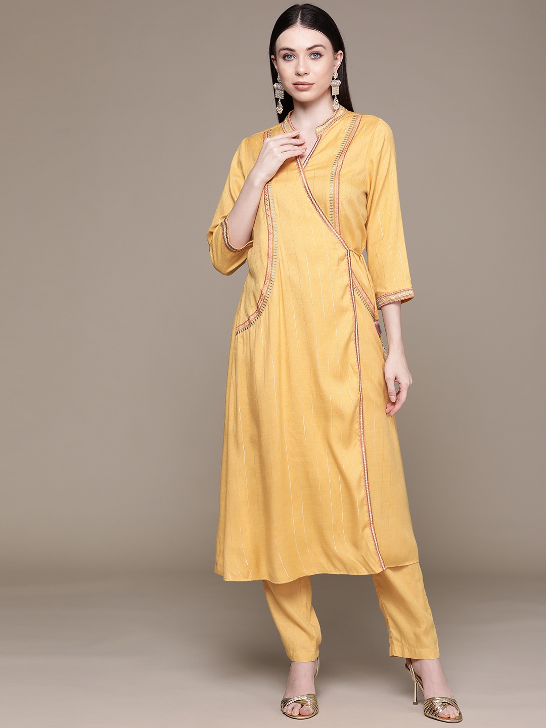 

aarke Ritu Kumar Women Striped Angrakha Thread Work Kurta with Trousers, Yellow