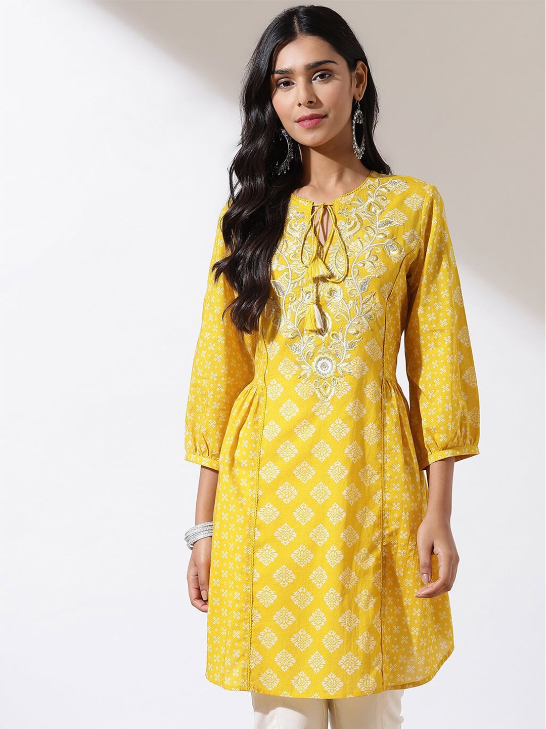 

Lakshita Ethnic Motifs Printed Tie Up Neck Thread Work Pure Cotton Kurti, Yellow