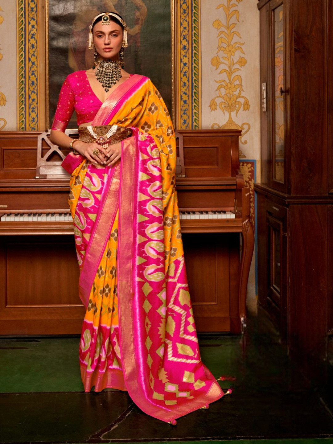 

Mitera Yellow & Pink Ethnic Motifs Printed Zari Patola Saree
