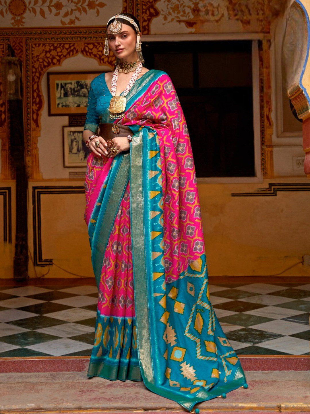 

Mitera Pink & Blue Ethnic Motifs Printed Zari Patola Saree