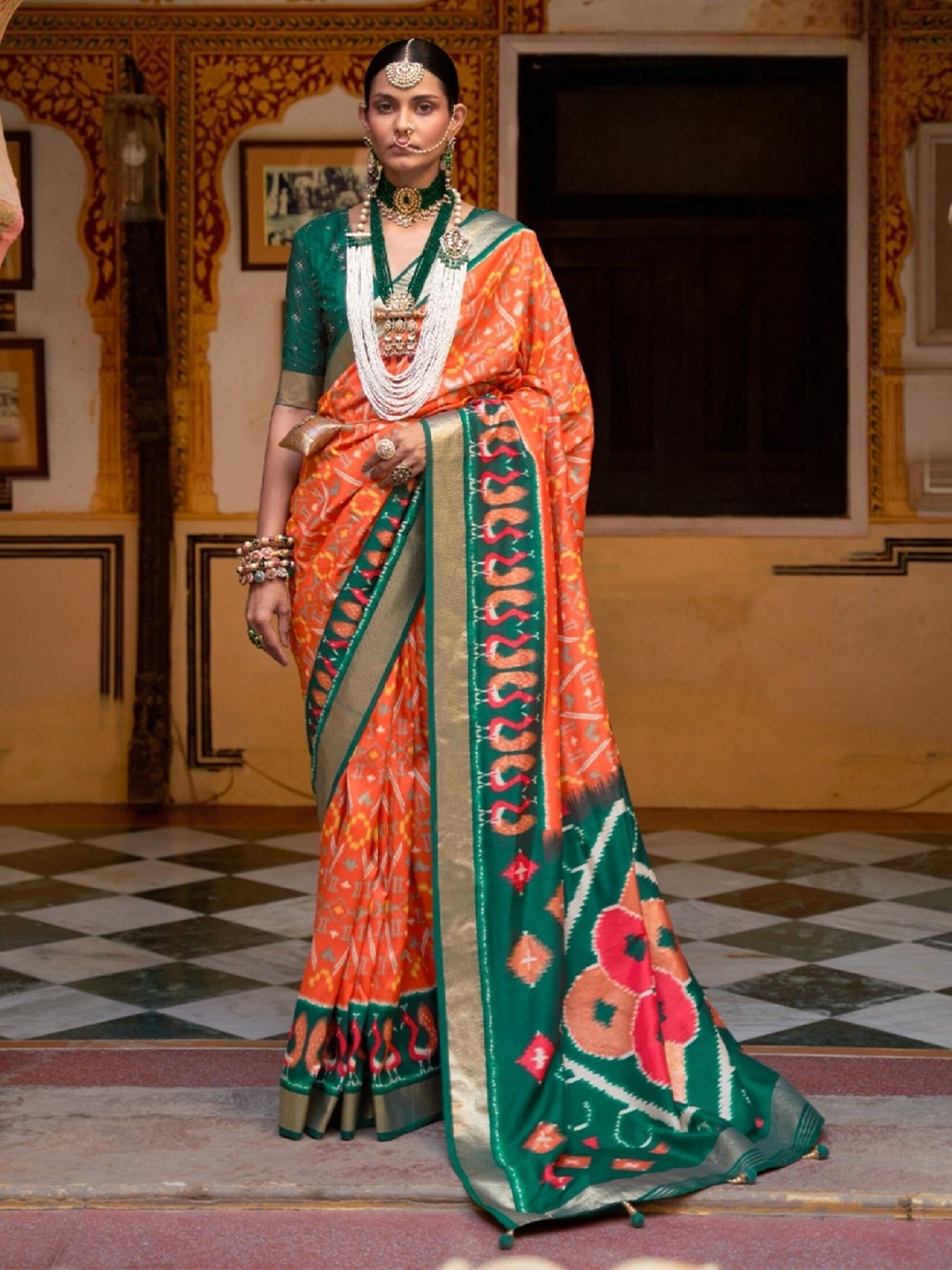 

Mitera Orange & Green Ethnic Motifs Printed Zari Patola Saree