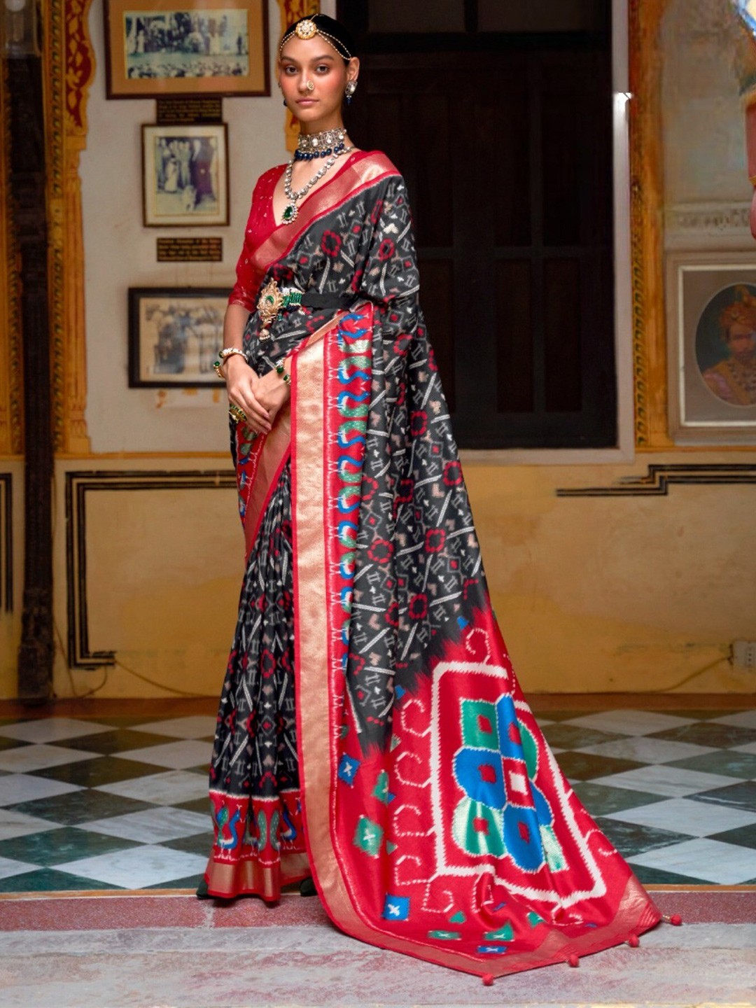 

Mitera Black & Red Ethnic Motifs Printed Zari Patola Saree