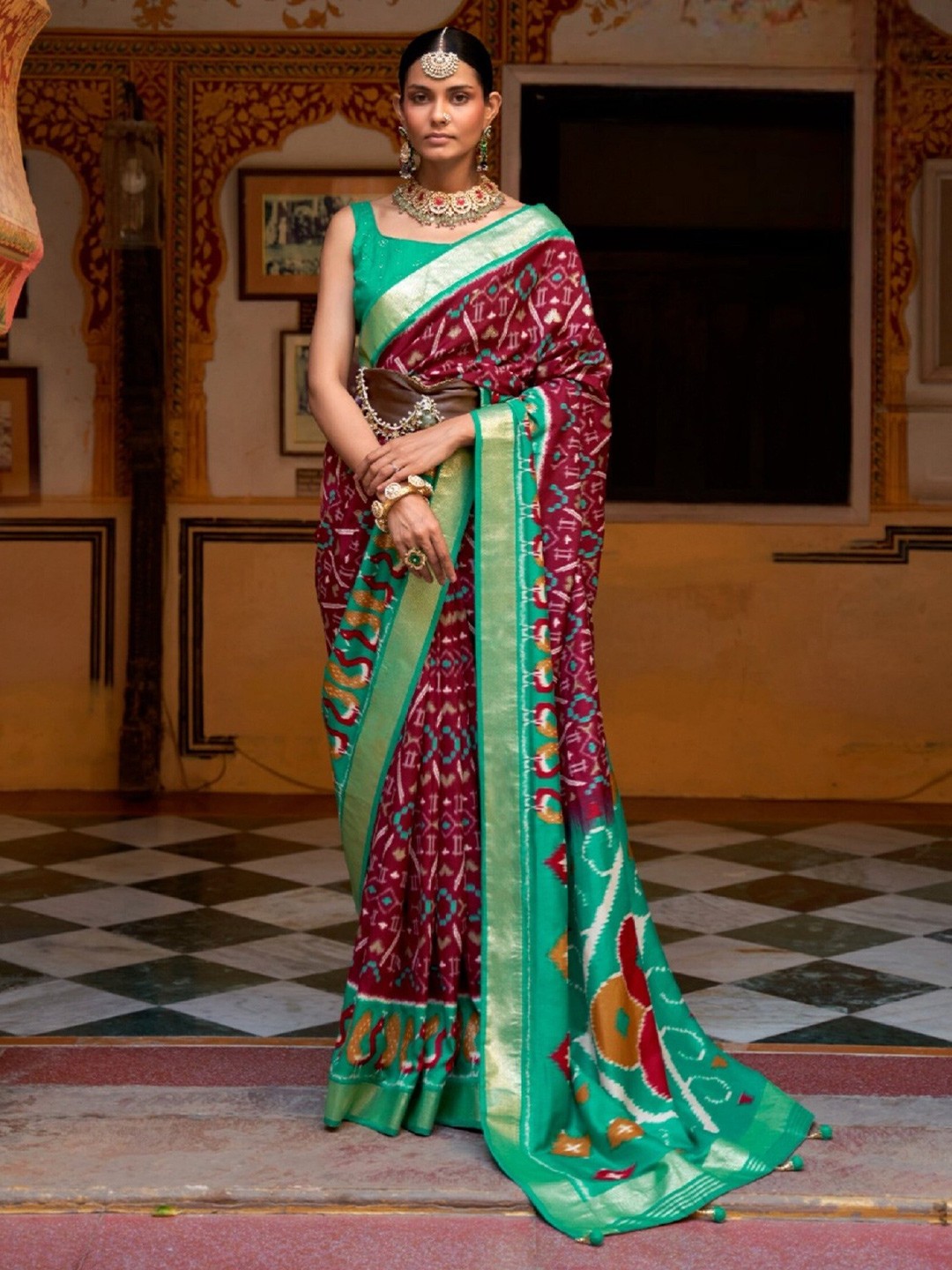 

Mitera Maroon & Green Ethnic Motifs Printed Zari Patola Saree
