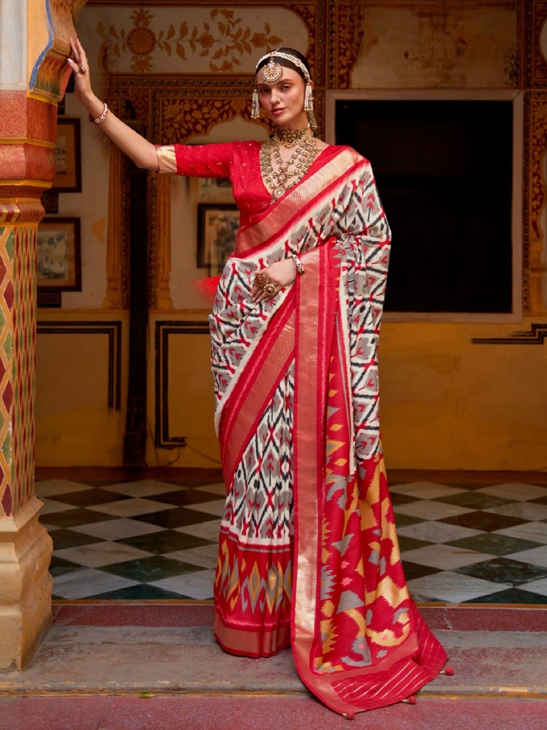 

Mitera Red & White Ethnic Motifs Printed Zari Patola Saree