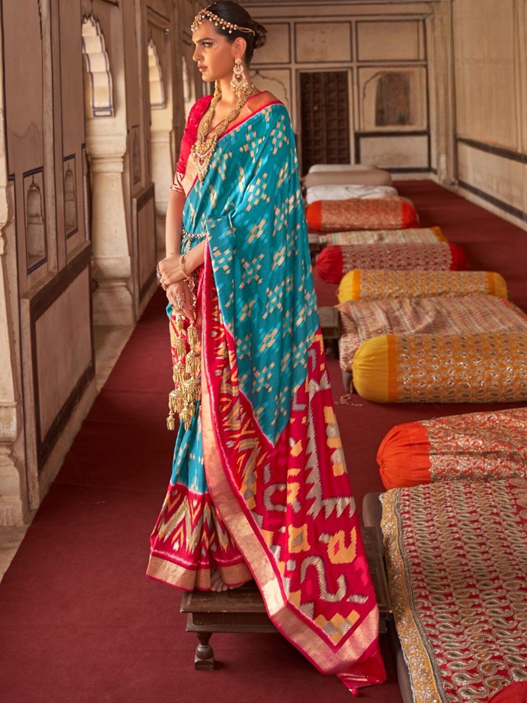 

Mitera Turquoise blue & Red Ethnic Motifs Printed Zari Patola Saree