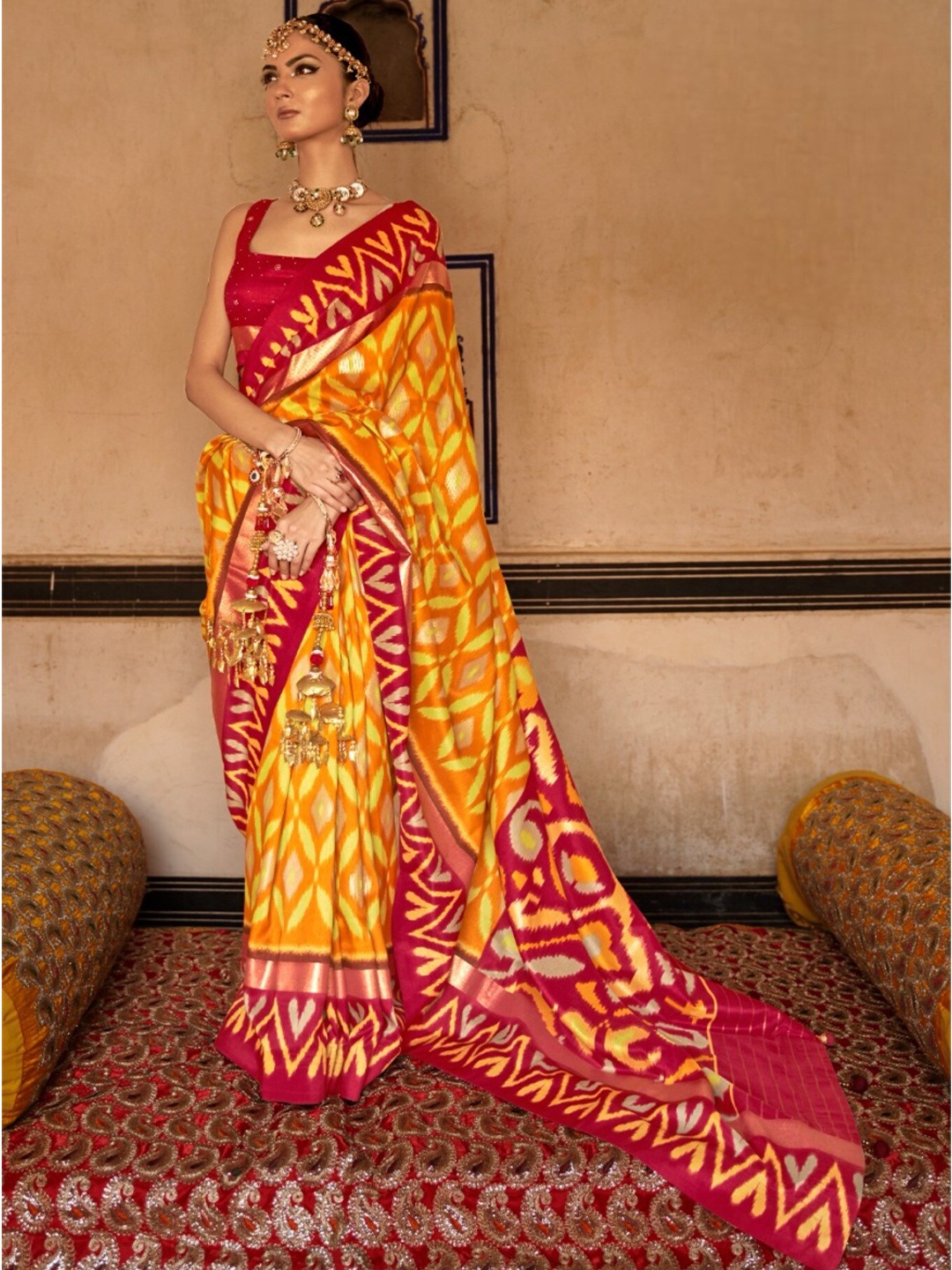 

Mitera Yellow & Red Ethnic Motifs Printed Zari Patola Saree