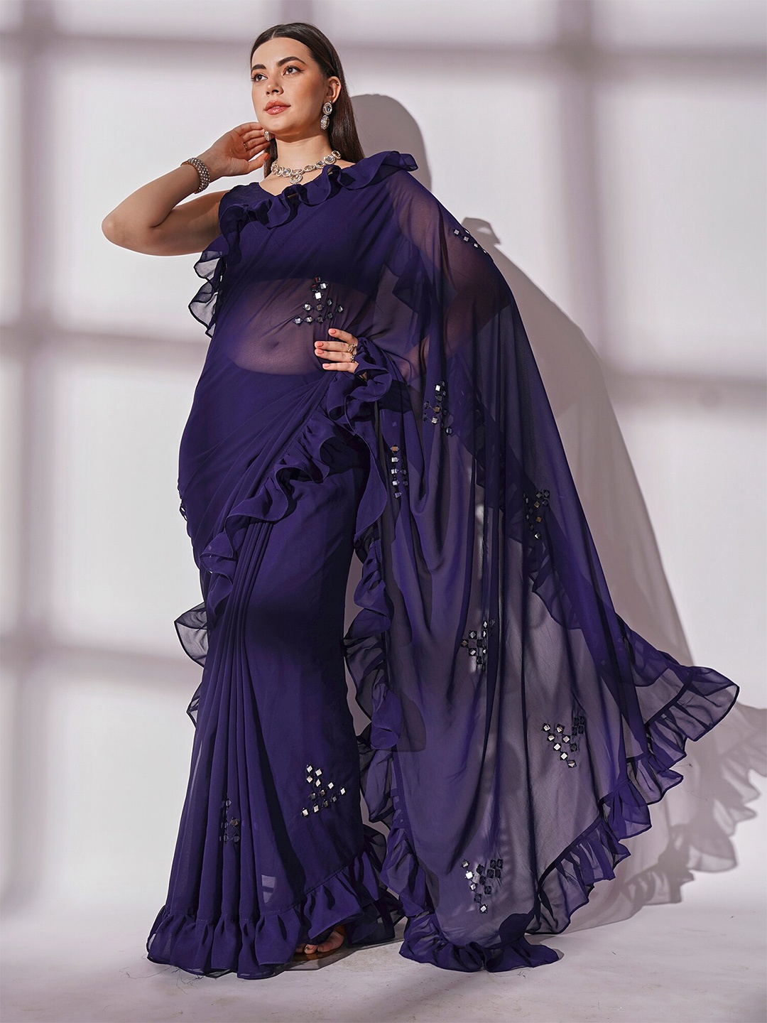 

Kalista Navy Blue Mirror Work Embellished Ruffled Border Georgette Saree