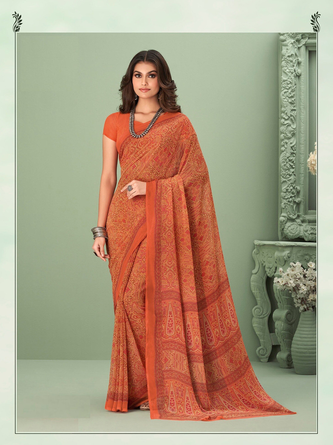 

Mitera Orange Ethnic Motifs Printed Poly Georgette Saree
