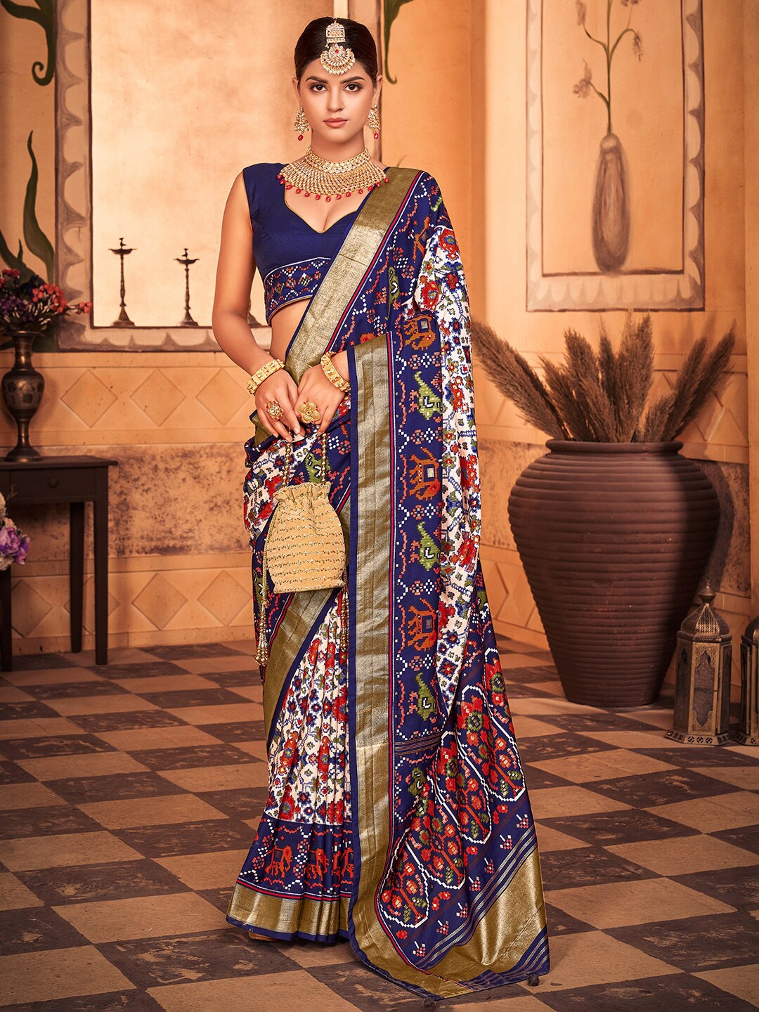 

Anouk White & Blue Ethnic Motifs Printed Zari Patola Saree