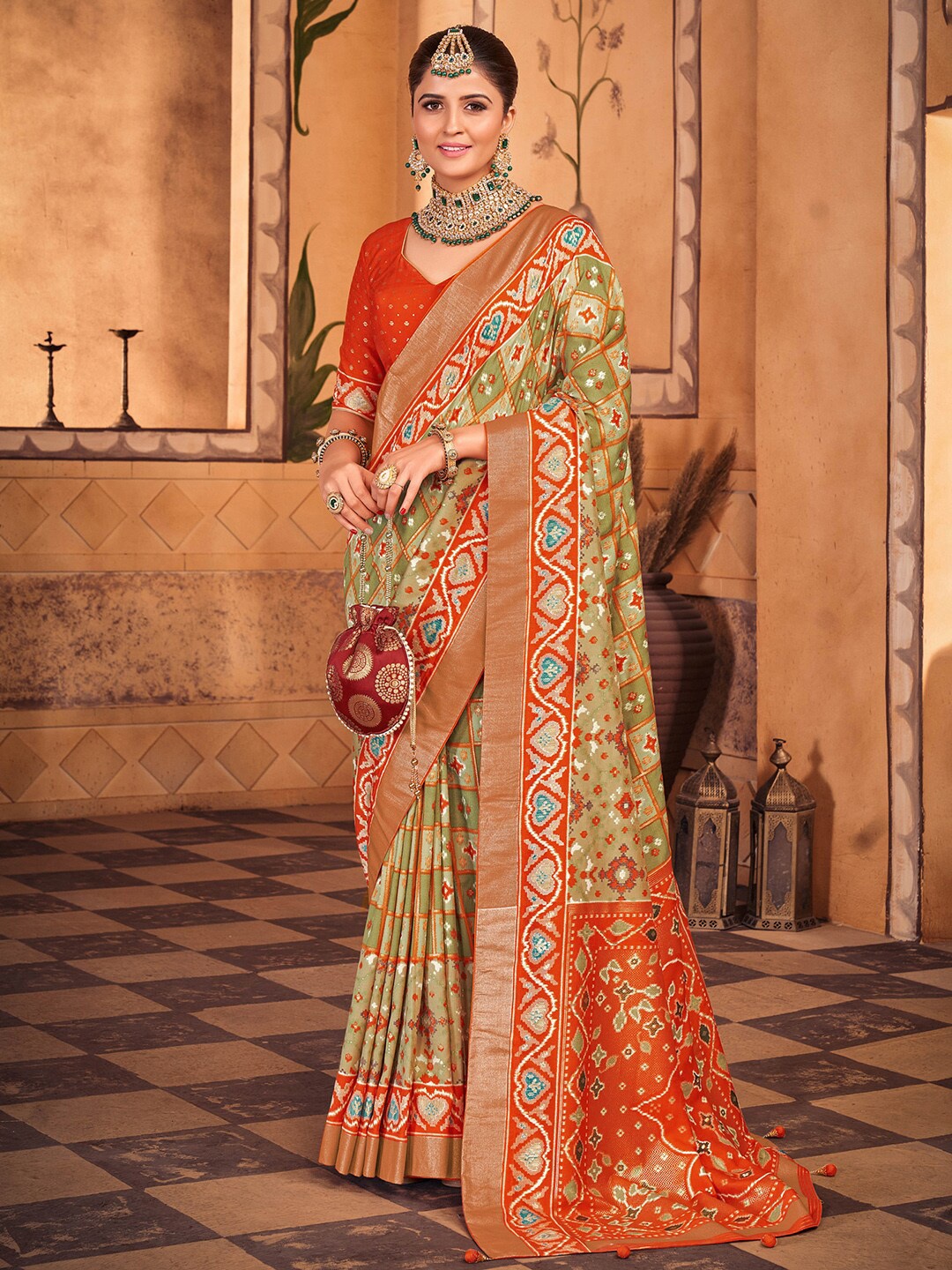 

Anouk Olive Green & Orange Ethnic Motifs Printed Zari Patola Saree