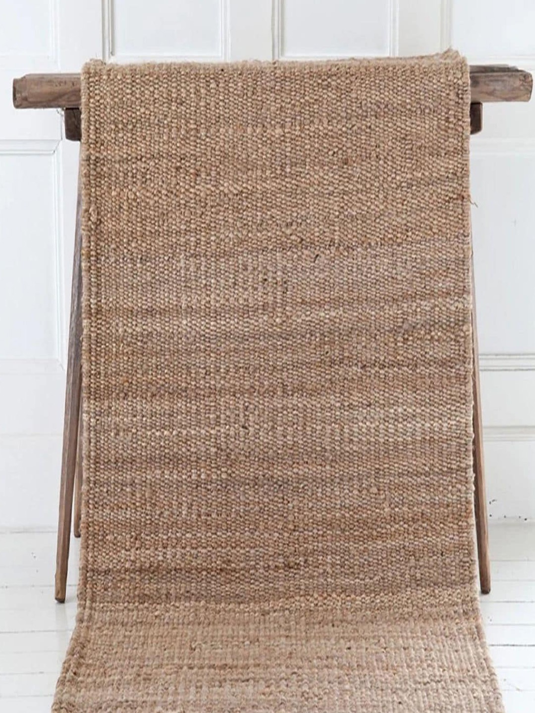 

THE HANDMADE FLAIR Beige Self Design Floor Carpet