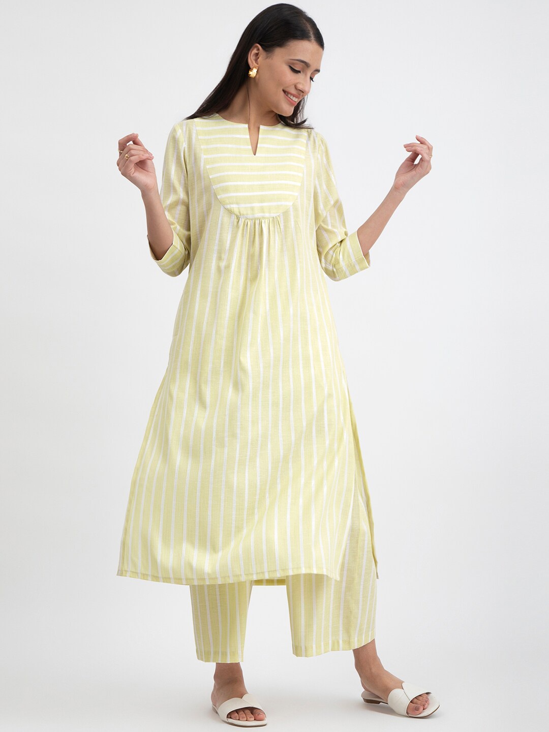

Pink Fort Notched Neck Striped A-line Kurta with Palazzos, Yellow