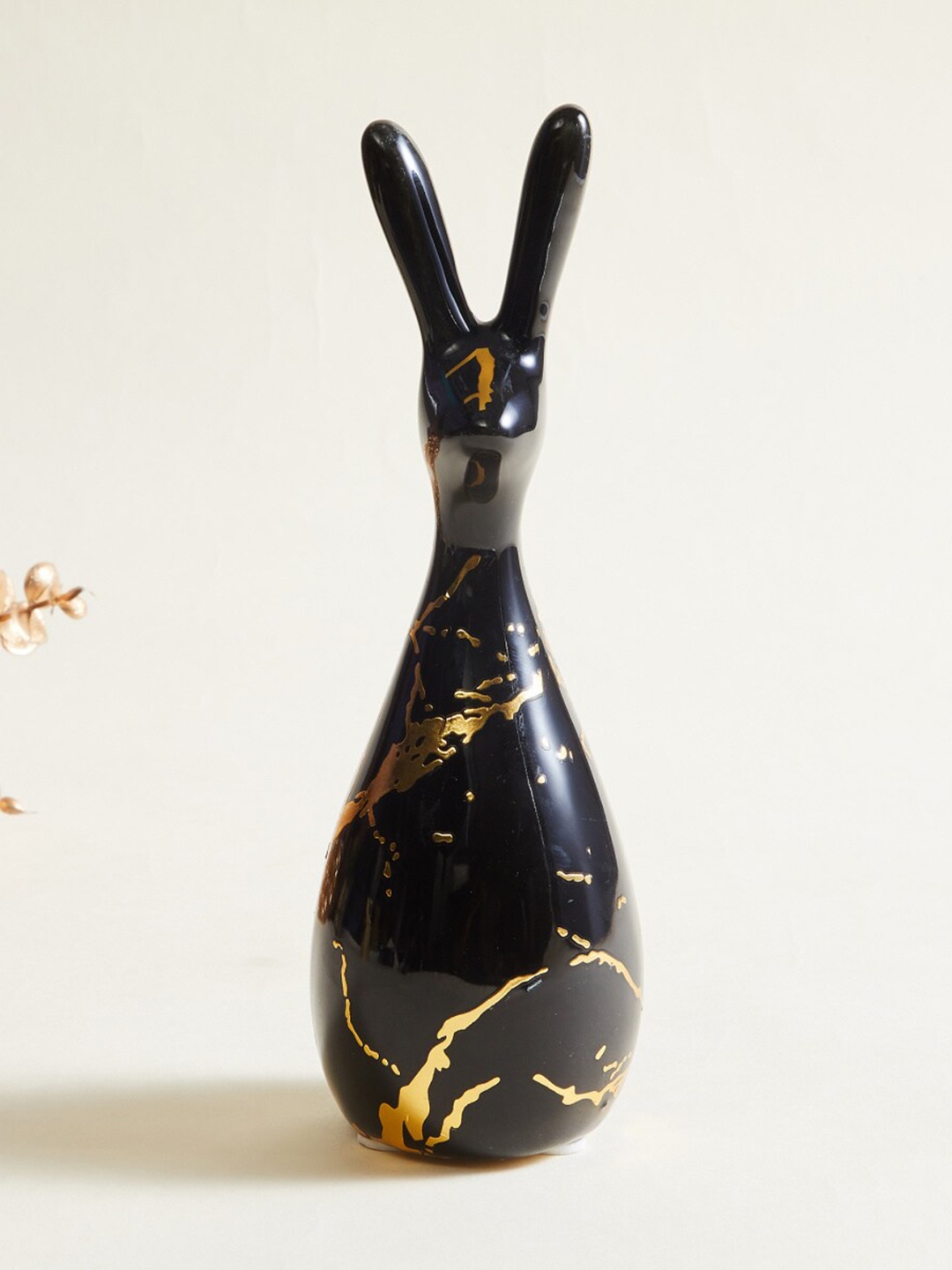 

Home Centre Black & Gold Printed Bunny Figurine Showpiece