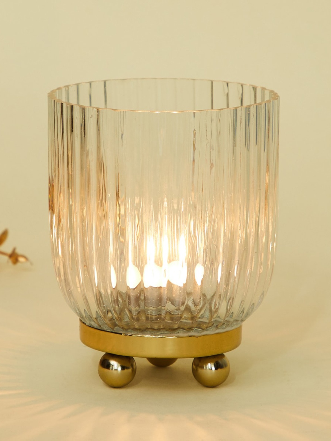 

Home Centre Metallic-Toned & Transparent Glass T-Light Holder With Metal Base, Gold