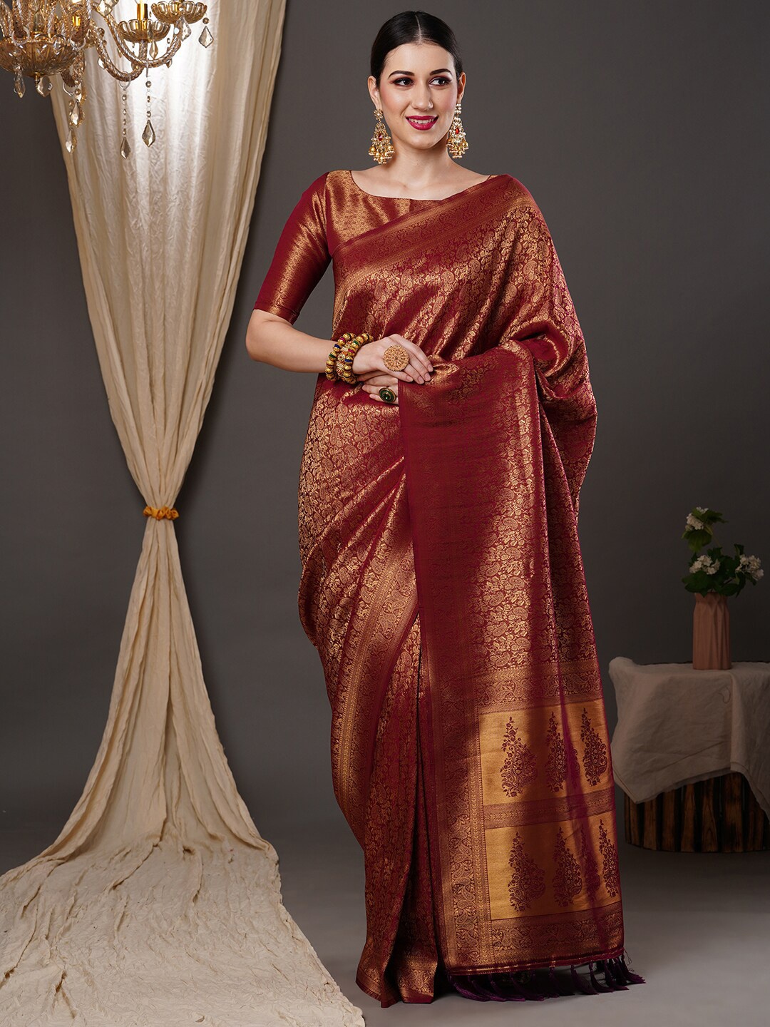 

Anouk Burgundy & Gold-Toned Ethnic Motif Woven Design Zari Kanjeevaram Saree