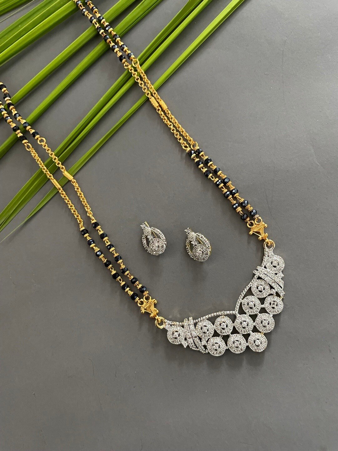 

Digital Dress Room Gold-Plated AD Studded Two-Line Long Mangalsutra Earrings