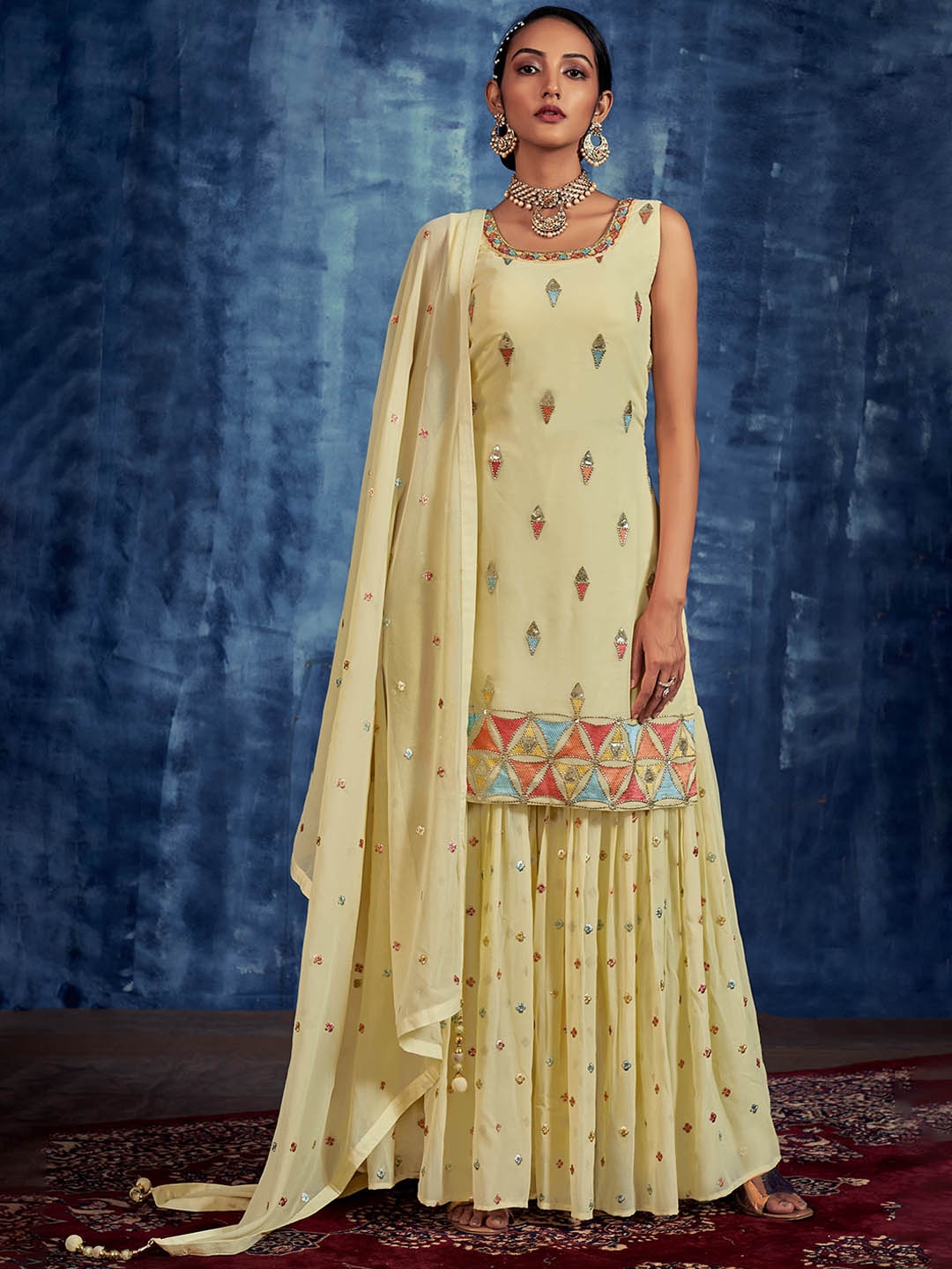 

Fusionic Yellow Ethnic Motifs Embroidered Beads & Stones Kurti with Sharara & Dupatta