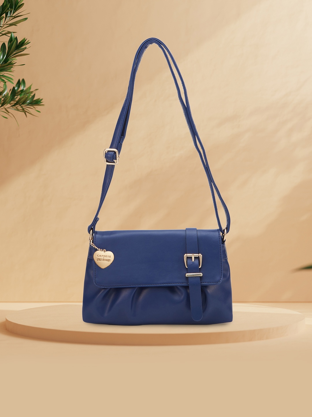 

Caprese Emily in Paris Structured Leather Buckle Detailed Sling Bag, Navy blue