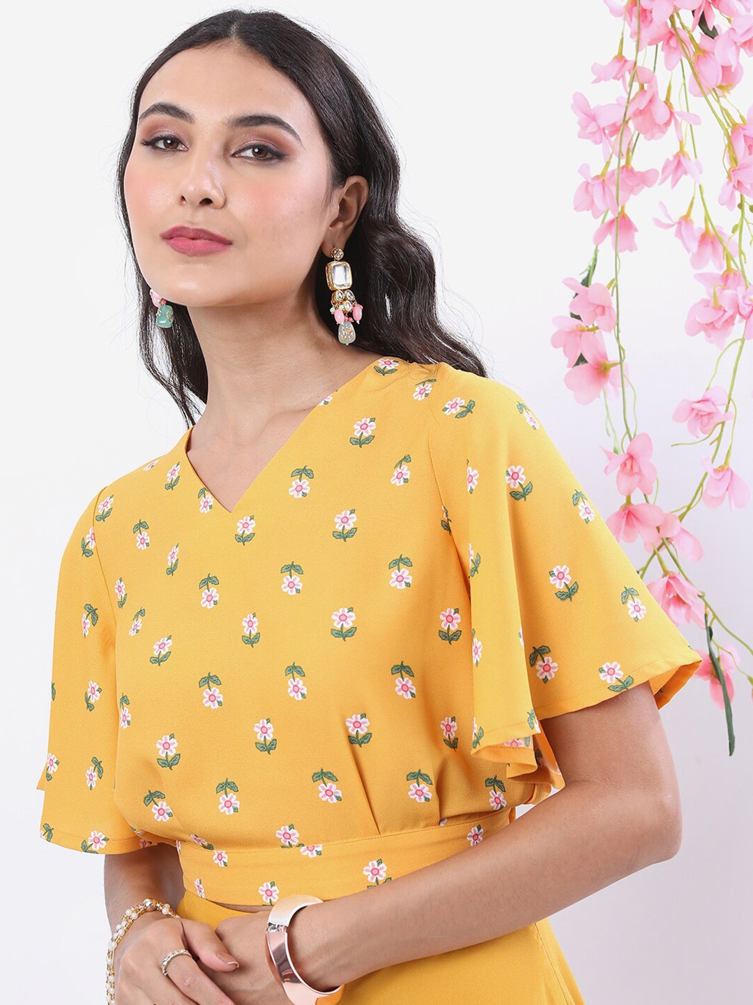 

Vishudh Yellow Floral Printed Flared Sleeves Blouson Crop Top, Mustard