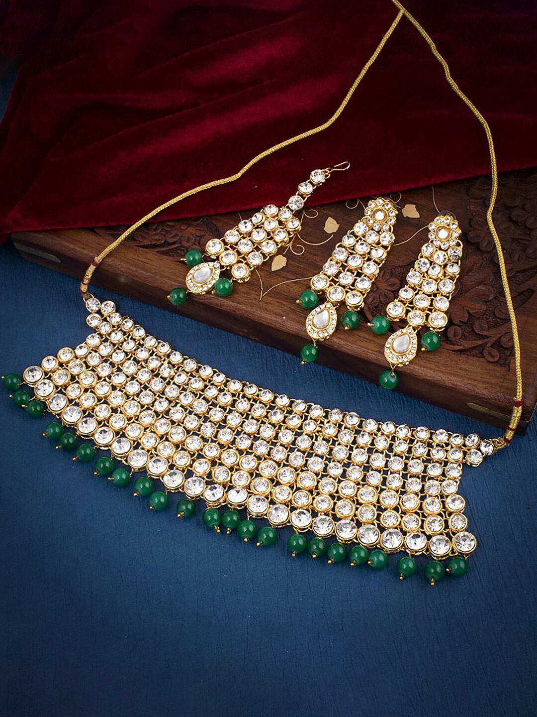 

Sukkhi Gold-Plated Stone-Studded Necklace And Earrings With Maang Tika Jewellery Set