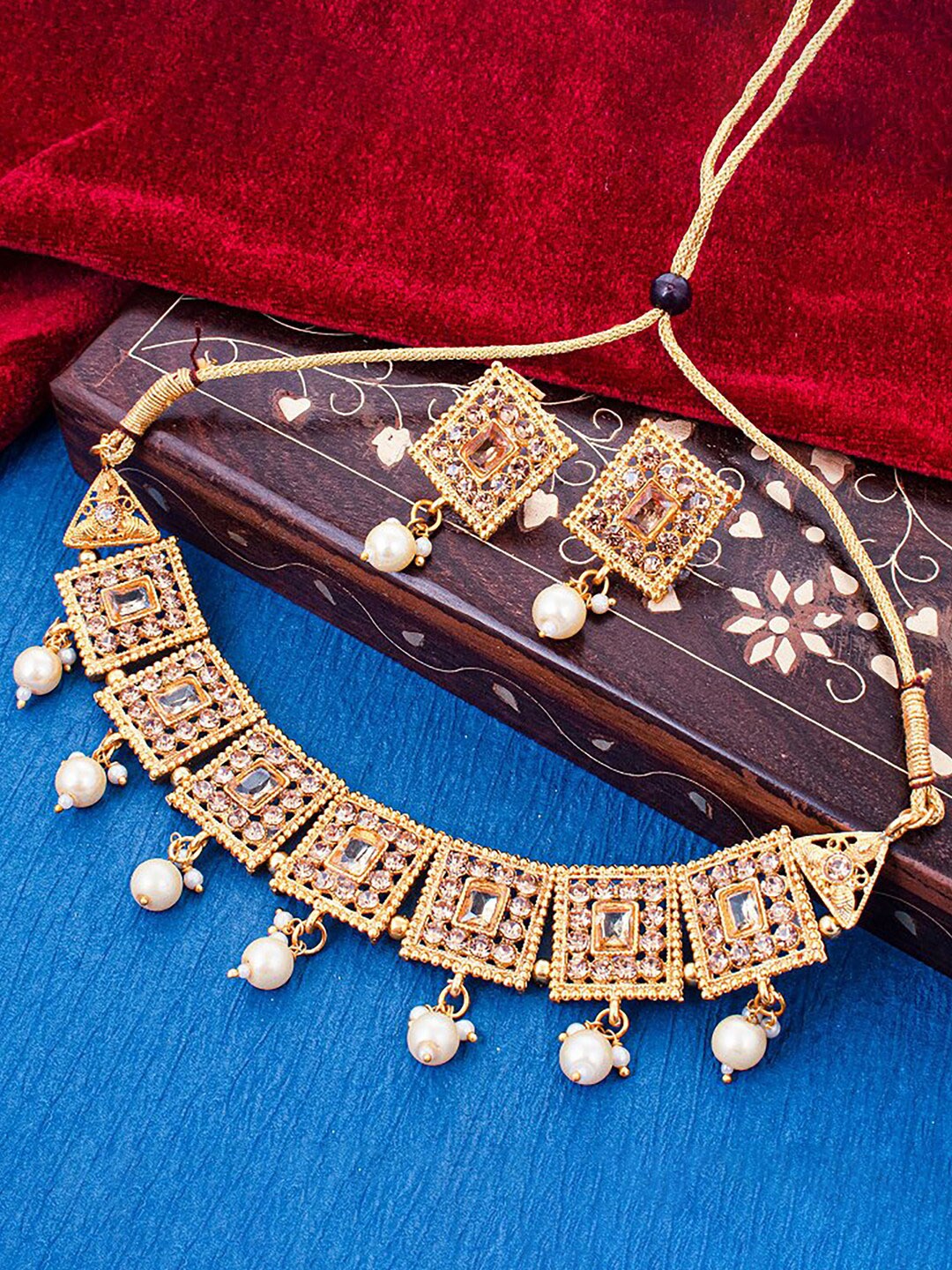 

Sukkhi Gold-Plated Artificial Stones and Beads Jewellery Set