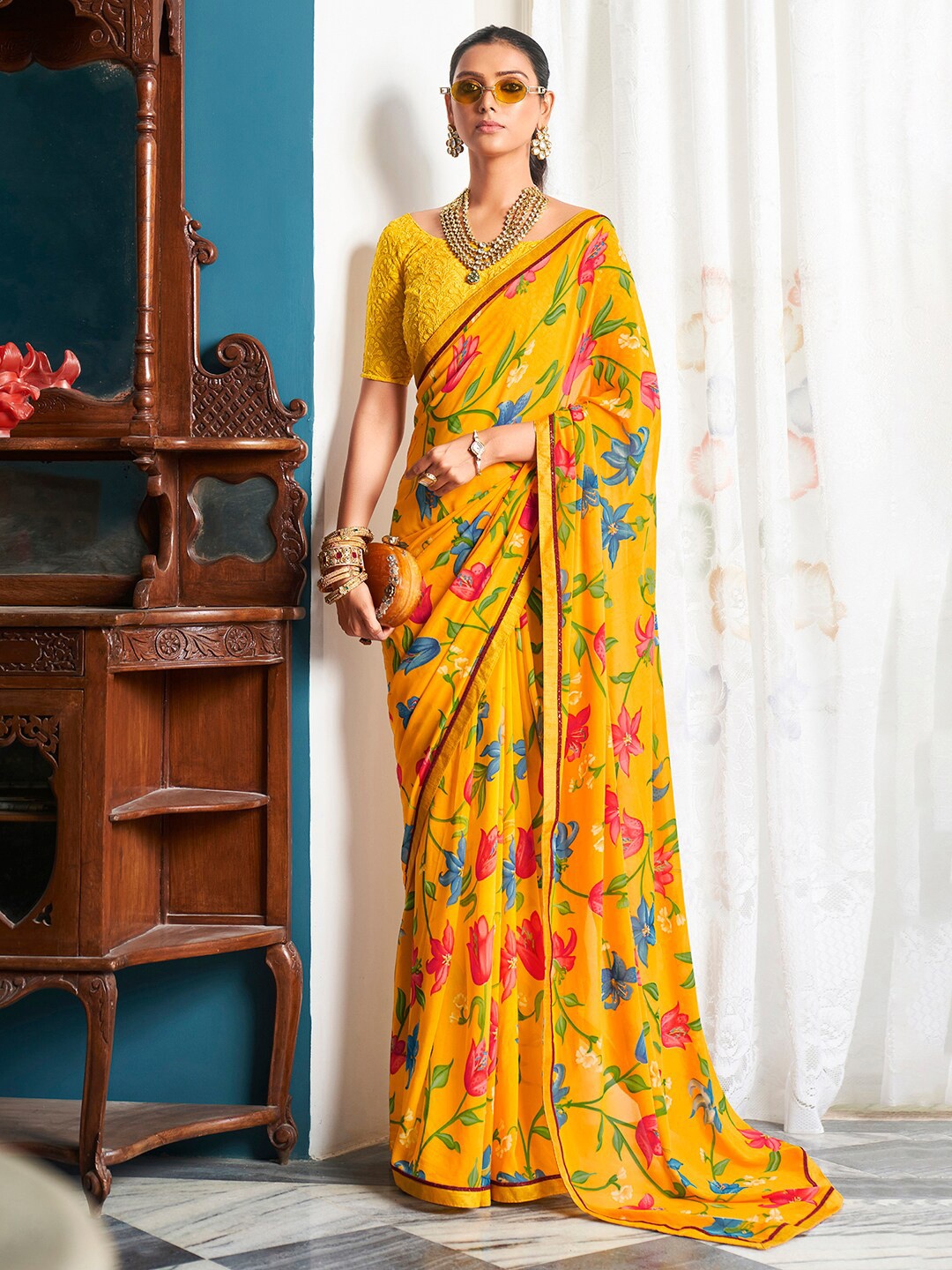 

Saree mall Yellow & Blue Floral Printed Pure Georgette Sarees