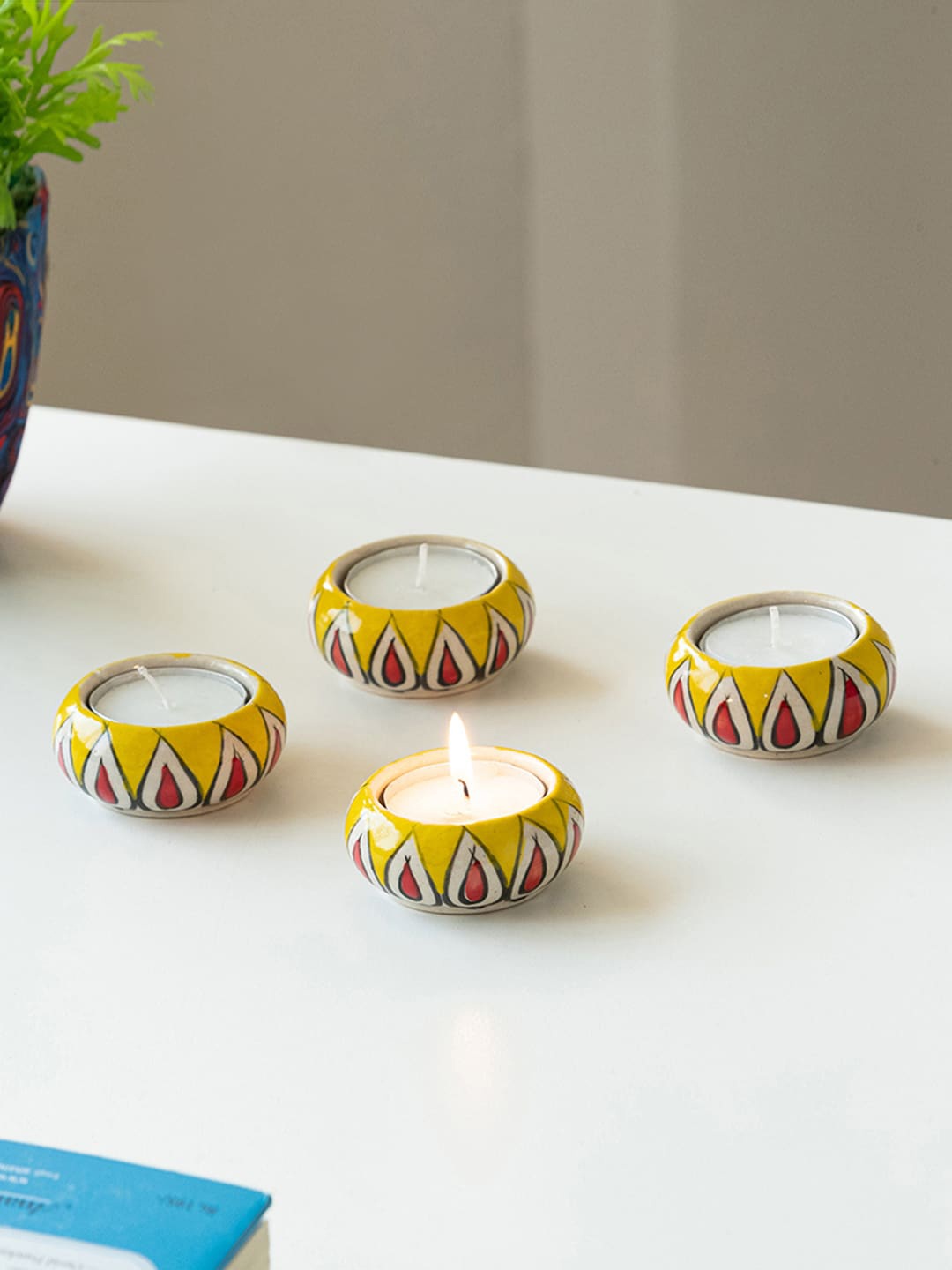 

ExclusiveLane Mughal Flaming Jugnu 4 Pieces Yellow Printed Jugnu Tea Light Holder