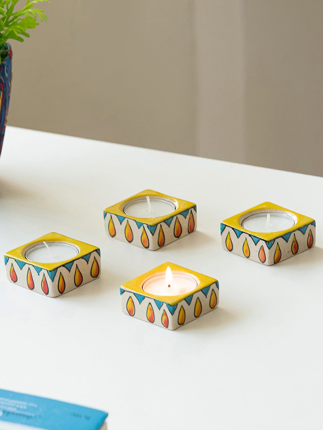 

ExclusiveLane Mughal Blazing Jungu 4 Pieces White & Yellow Printed Tea Light Holder