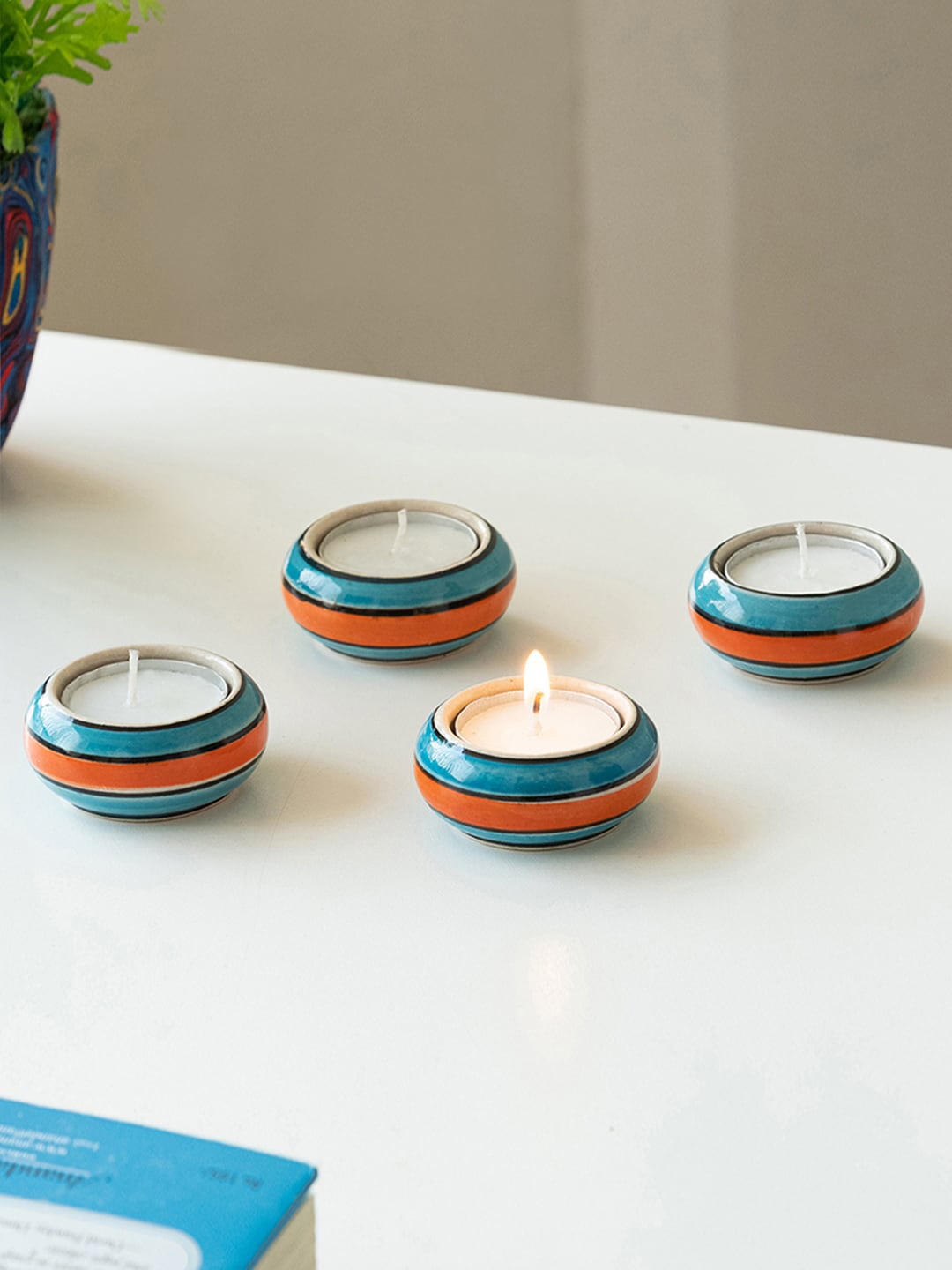 

ExclusiveLane Mughal Rolling Jugnu Blue & Orange 4 Pieces Tea Light Candle Holders