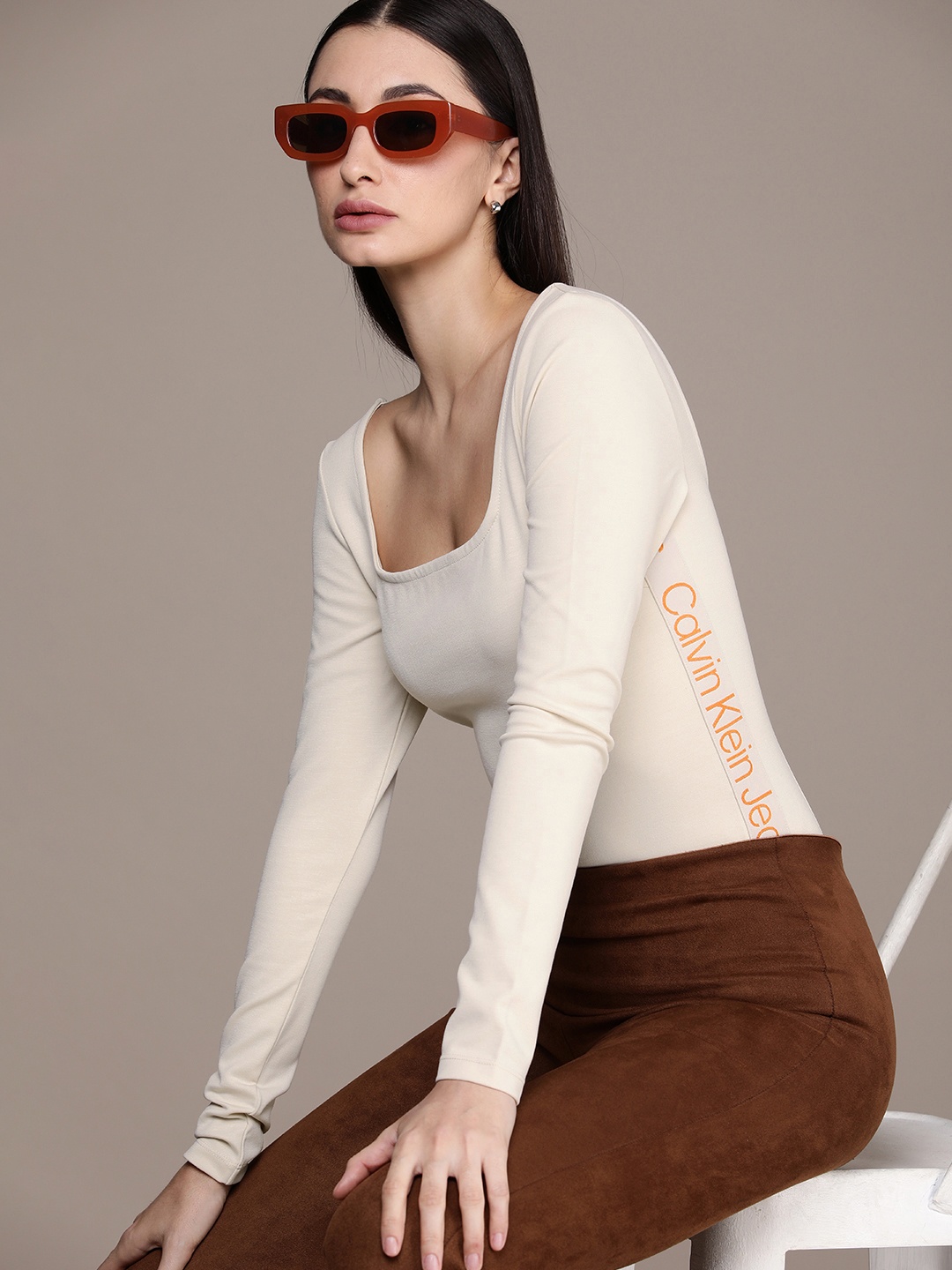 

Calvin Klein Jeans Women Solid Brand Logo Tape Detail Scoop Neck Bodysuit, Beige