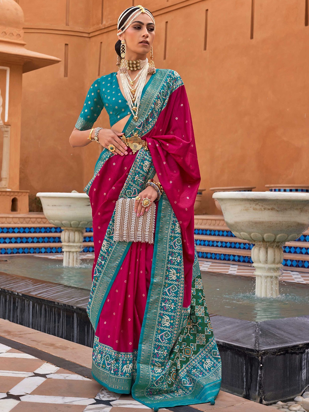 

Mitera Pink & Blue Ethnic Motifs Woven Design Zari Silk Blend Patola Saree