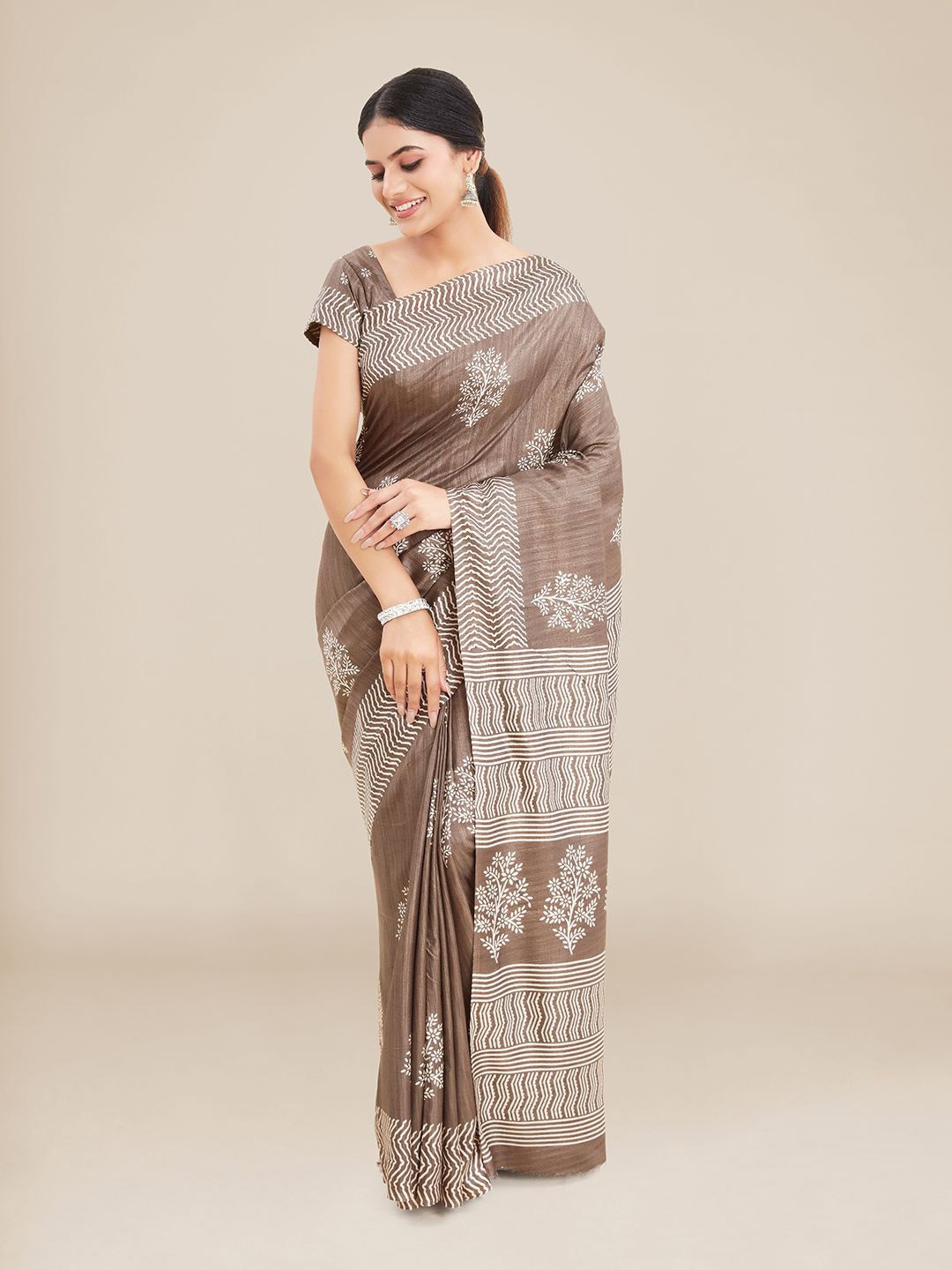 

Kalyan Silks Brown & White Floral Art Silk Tussar Saree