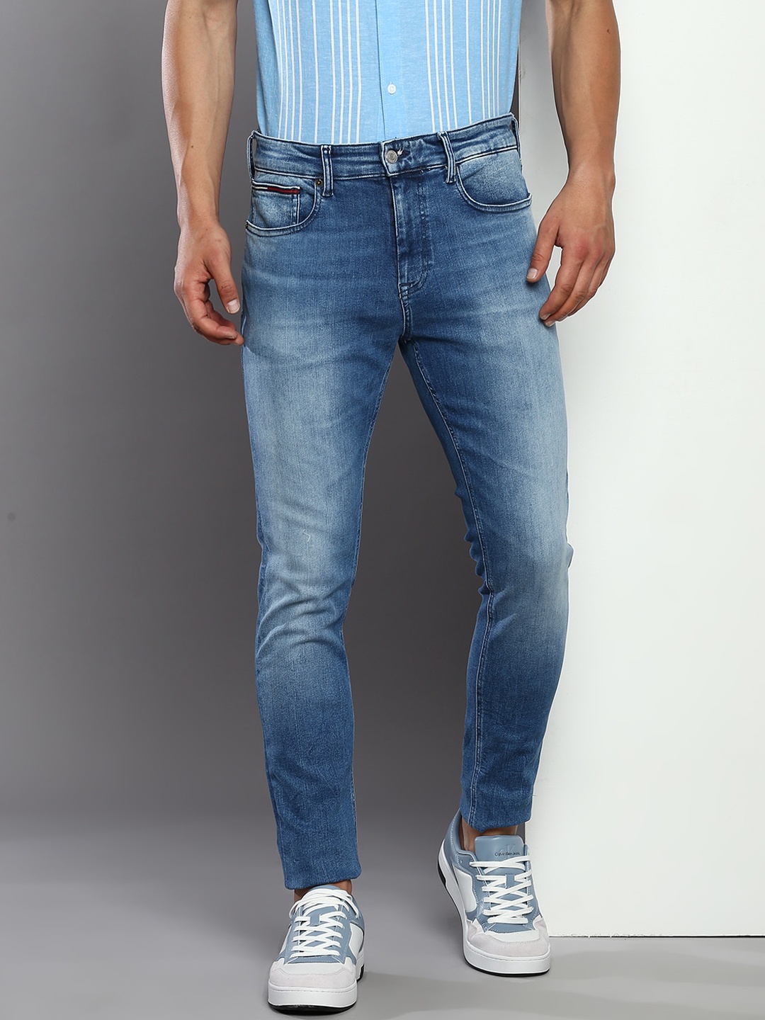 

Tommy Hilfiger Men Tapered Fit Clean Look Light Fade Mid Rise Cotton Jeans, Blue