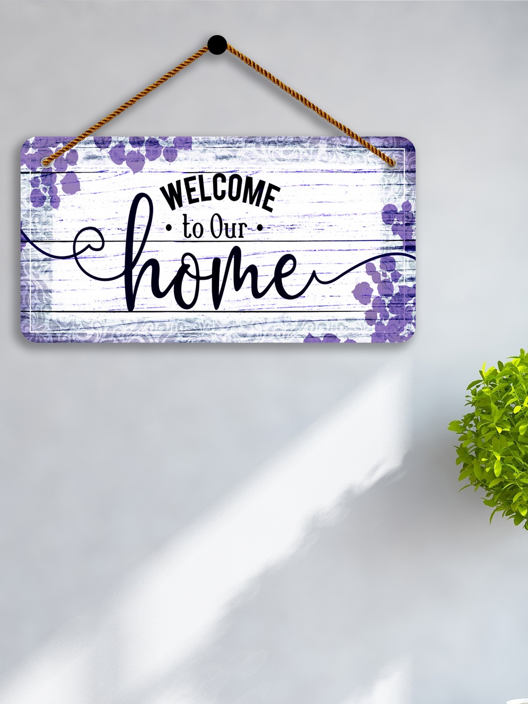

SAF White & Purple Welcome To Our Home Printed Wooden Wall Hanging With Zardoori String