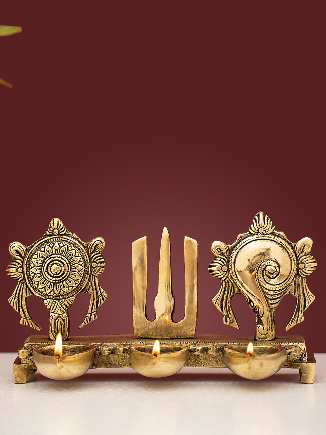 

DecorTwist Gold-Toned Shankh Chakra Brass Diya