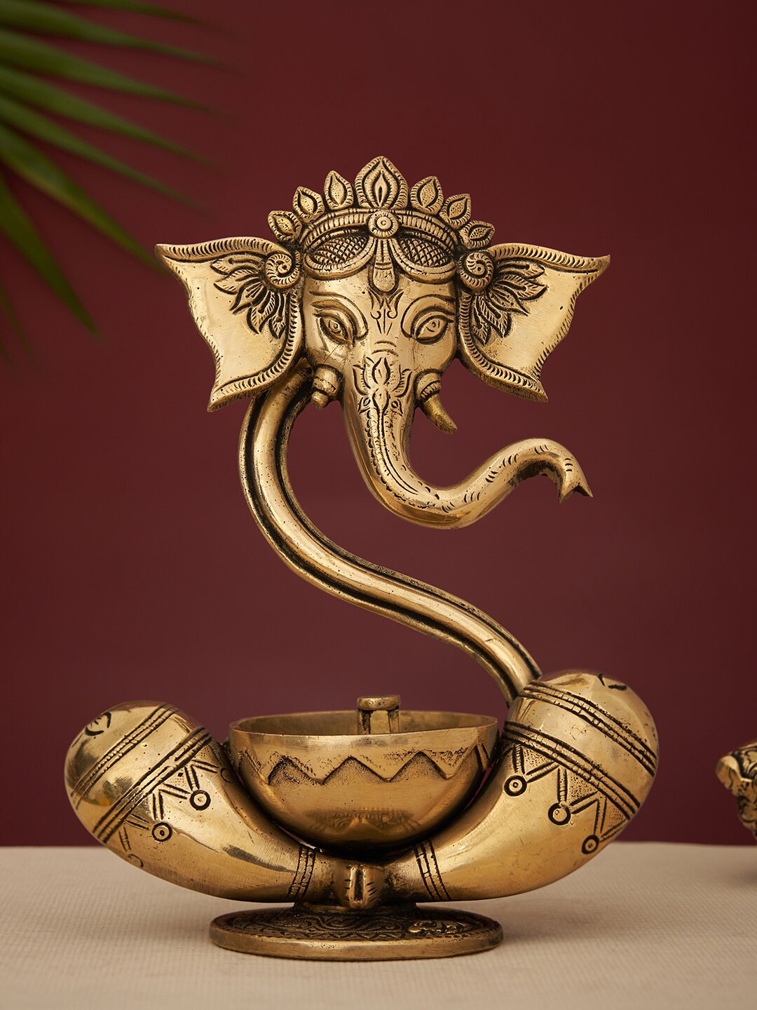 

DecorTwist Gold-Toned Brass Ganesha Idol Akhand Diya