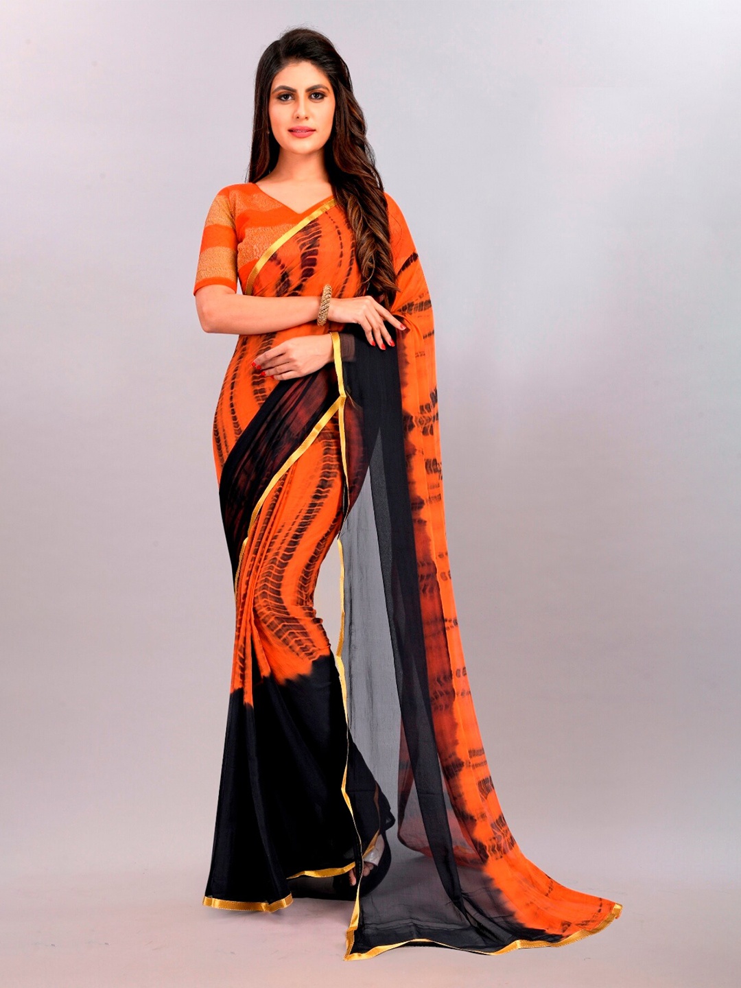 

APNISHA Orange & Black Tie and Dye Zari Poly Chiffon Leheriya Saree