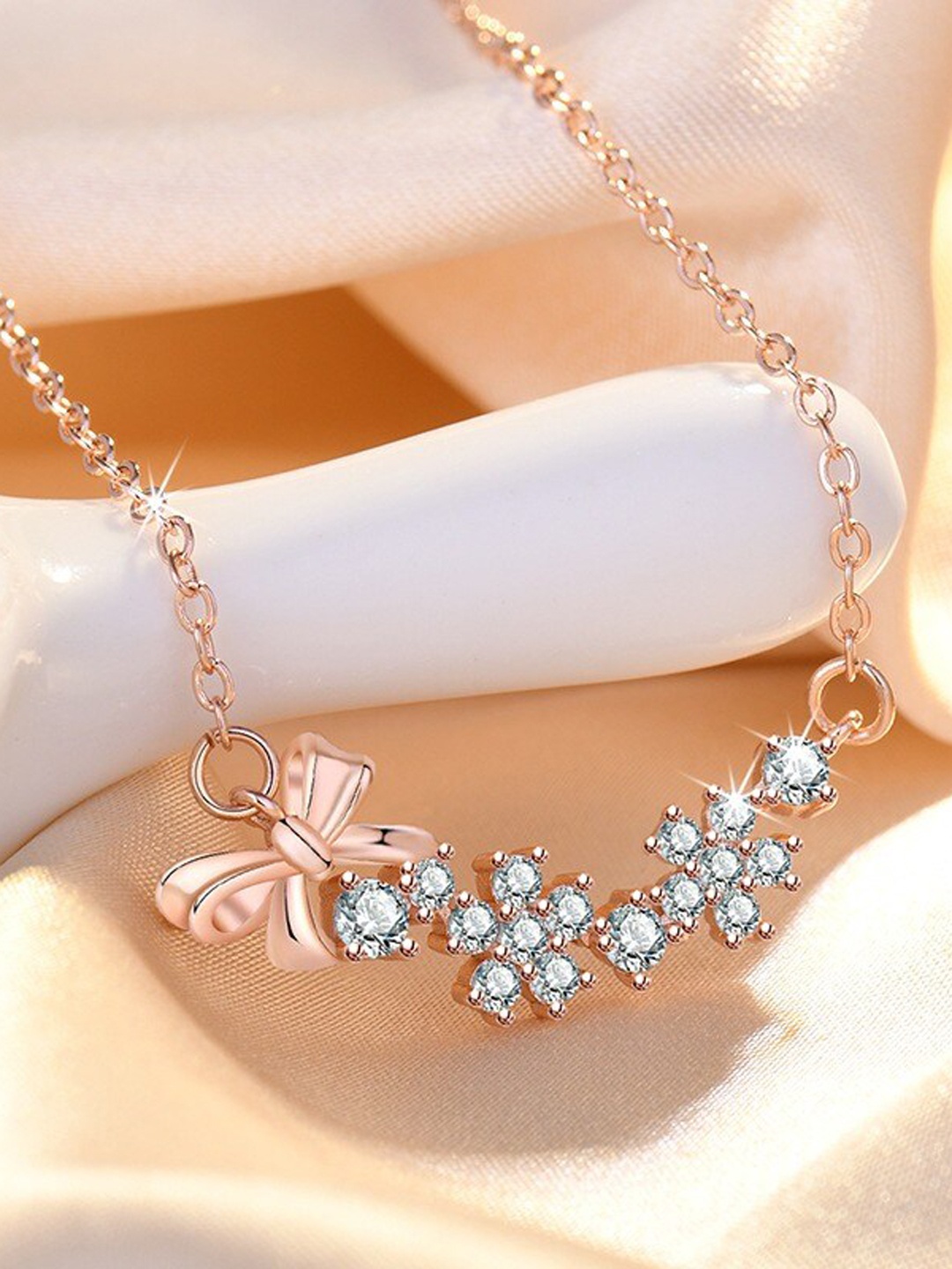

MYKI Rose Gold-Plated Cubic Zirconia Studded Bow Pendant