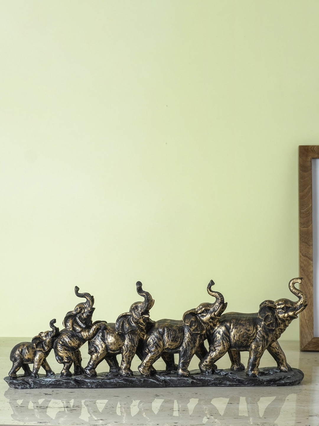 

The Decor Mart Gold Toned & Black Five Elephants on Base Animal Figurine Showpiece